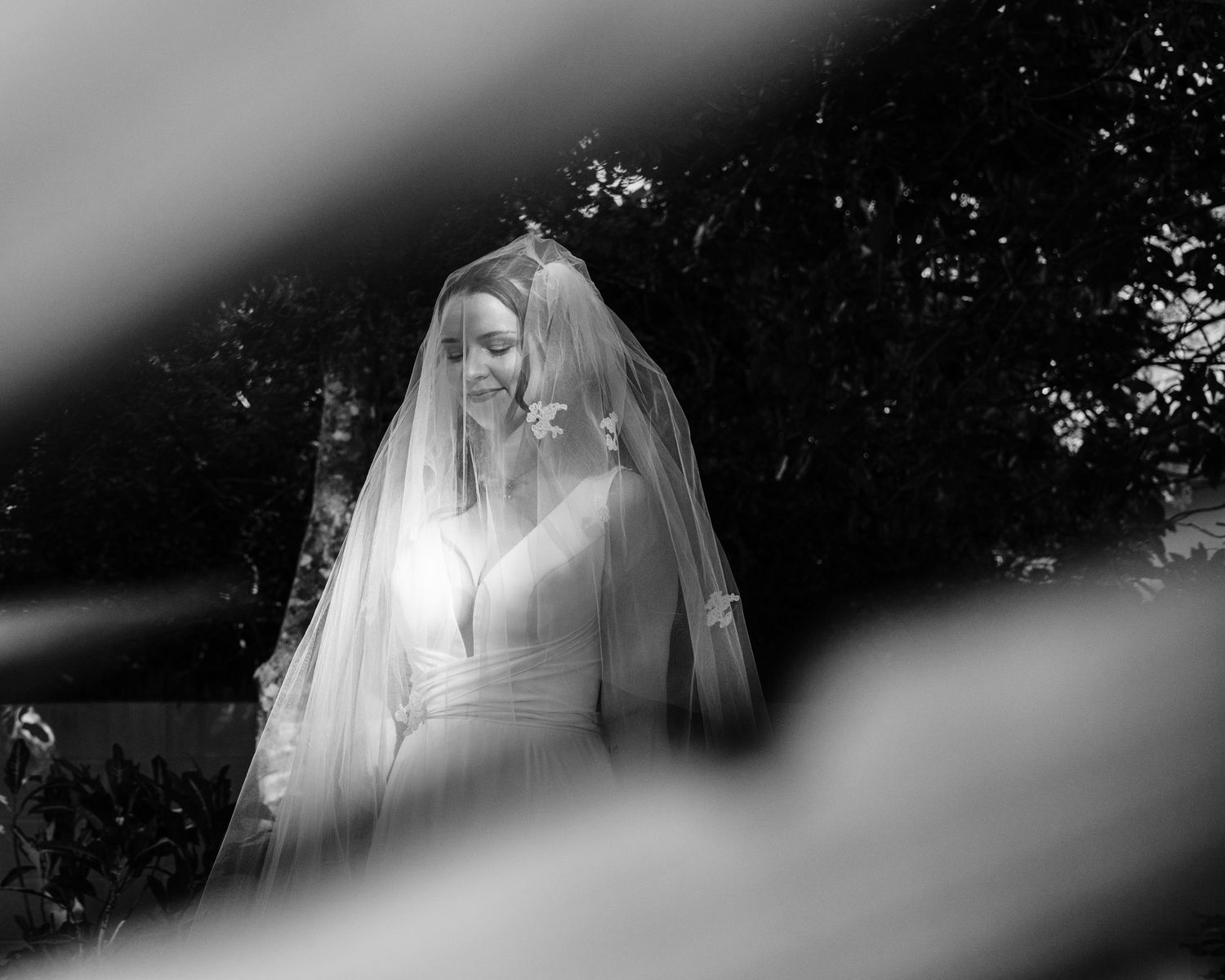 Ethereal white veil flowing in soft focus against a dark background.