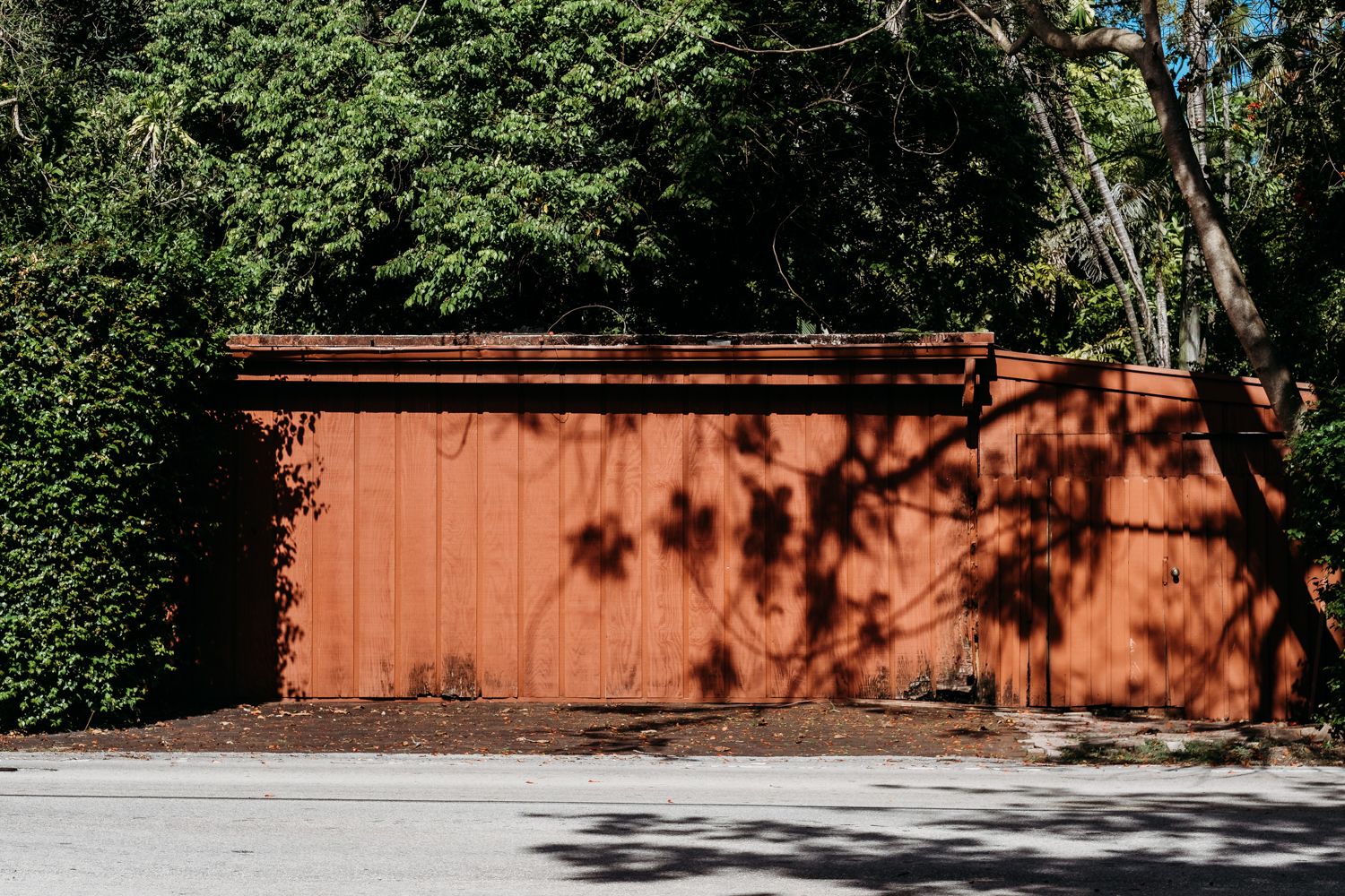 Sequence of images showing a wooden fence casting shadows on a concrete surface during different times of day.