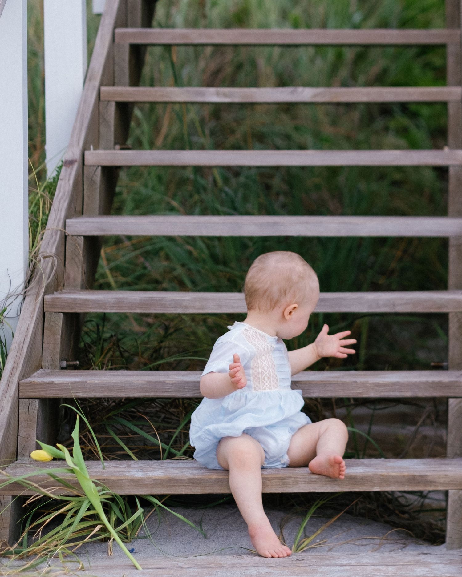 Series of photos showing a baby crawling and exploring wooden steps outdoors.