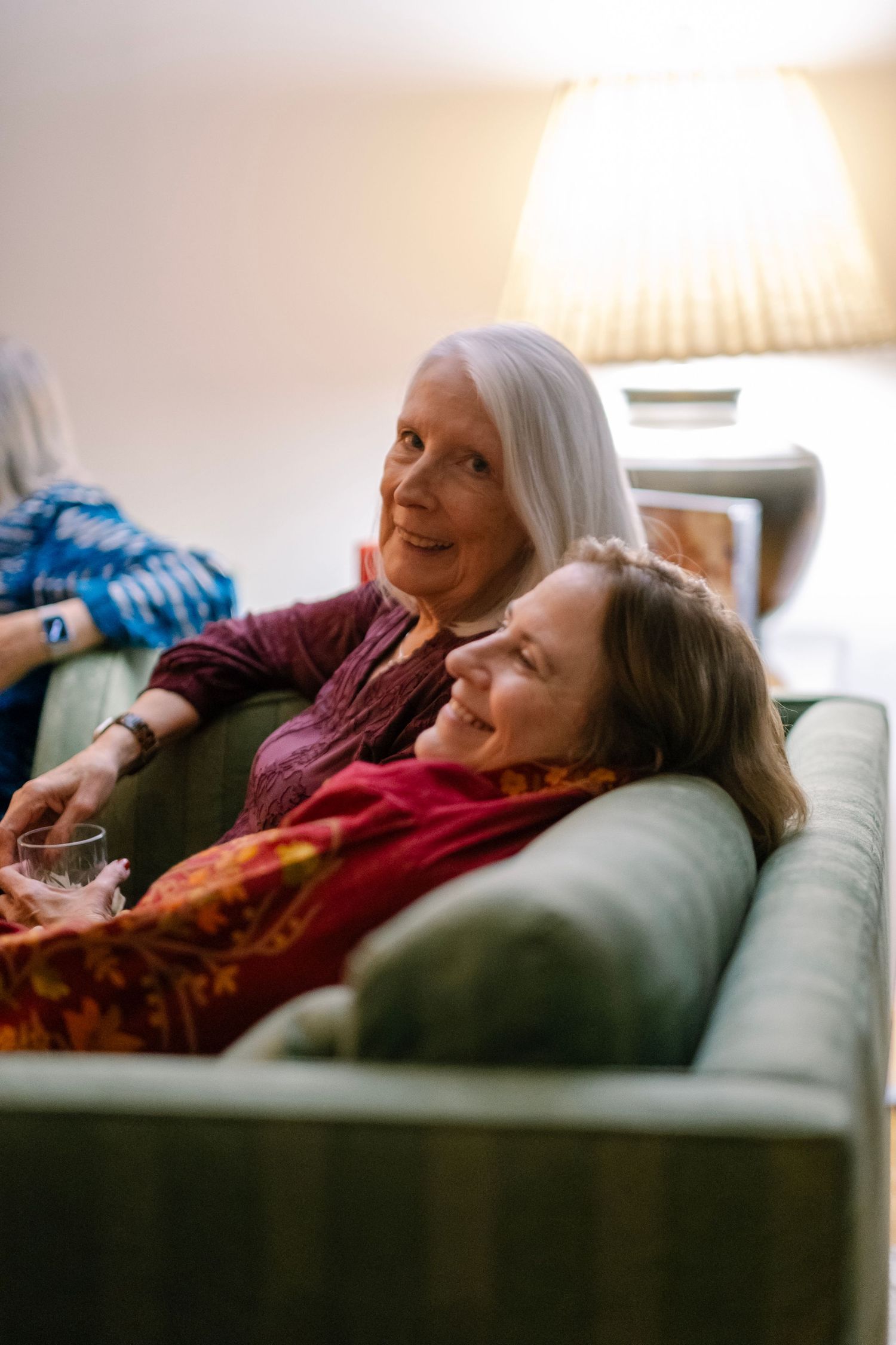 Relaxed moments shared on a comfortable green couch in natural lighting.