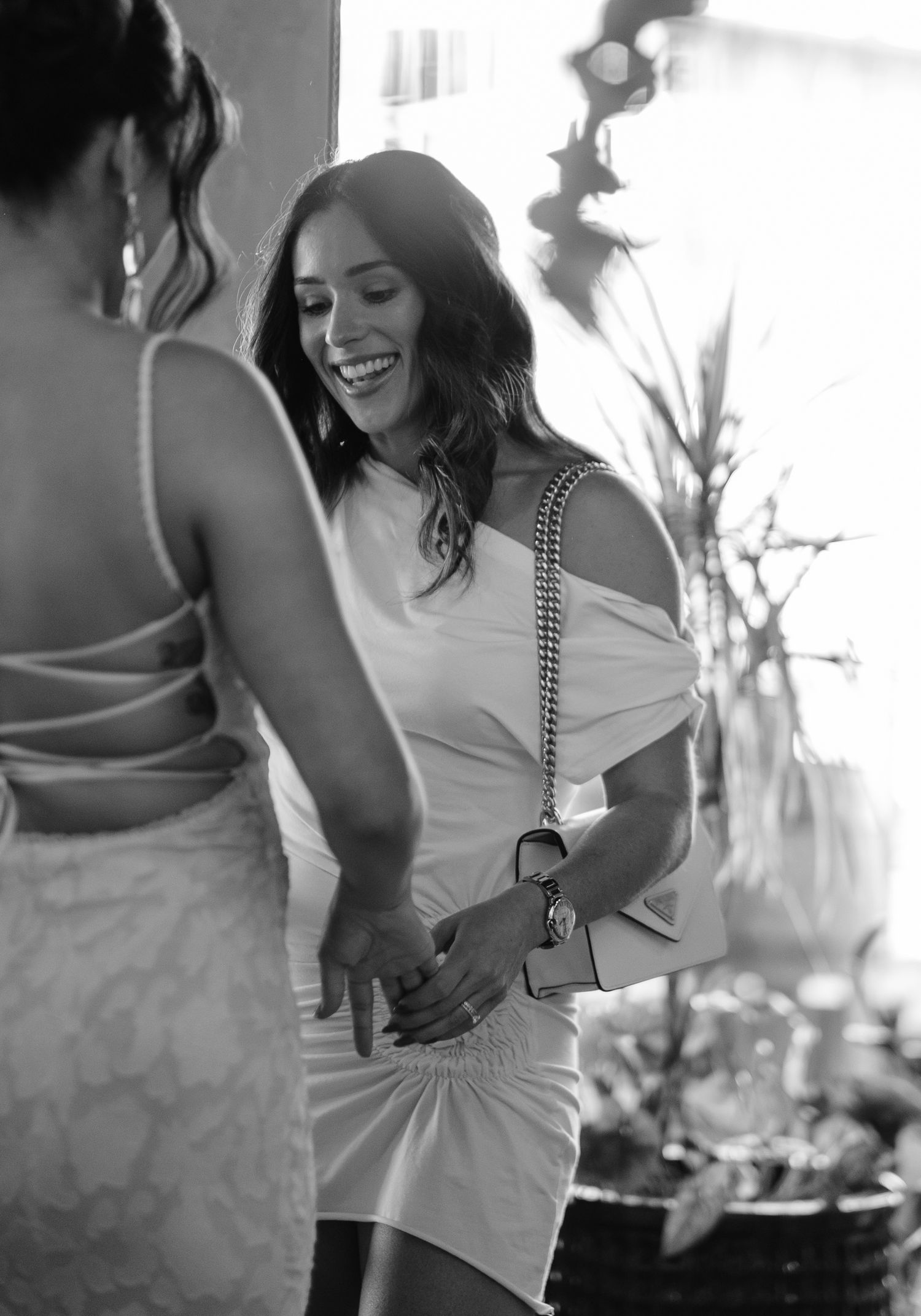 Black and white candid shots of people dancing and celebrating at an indoor event.