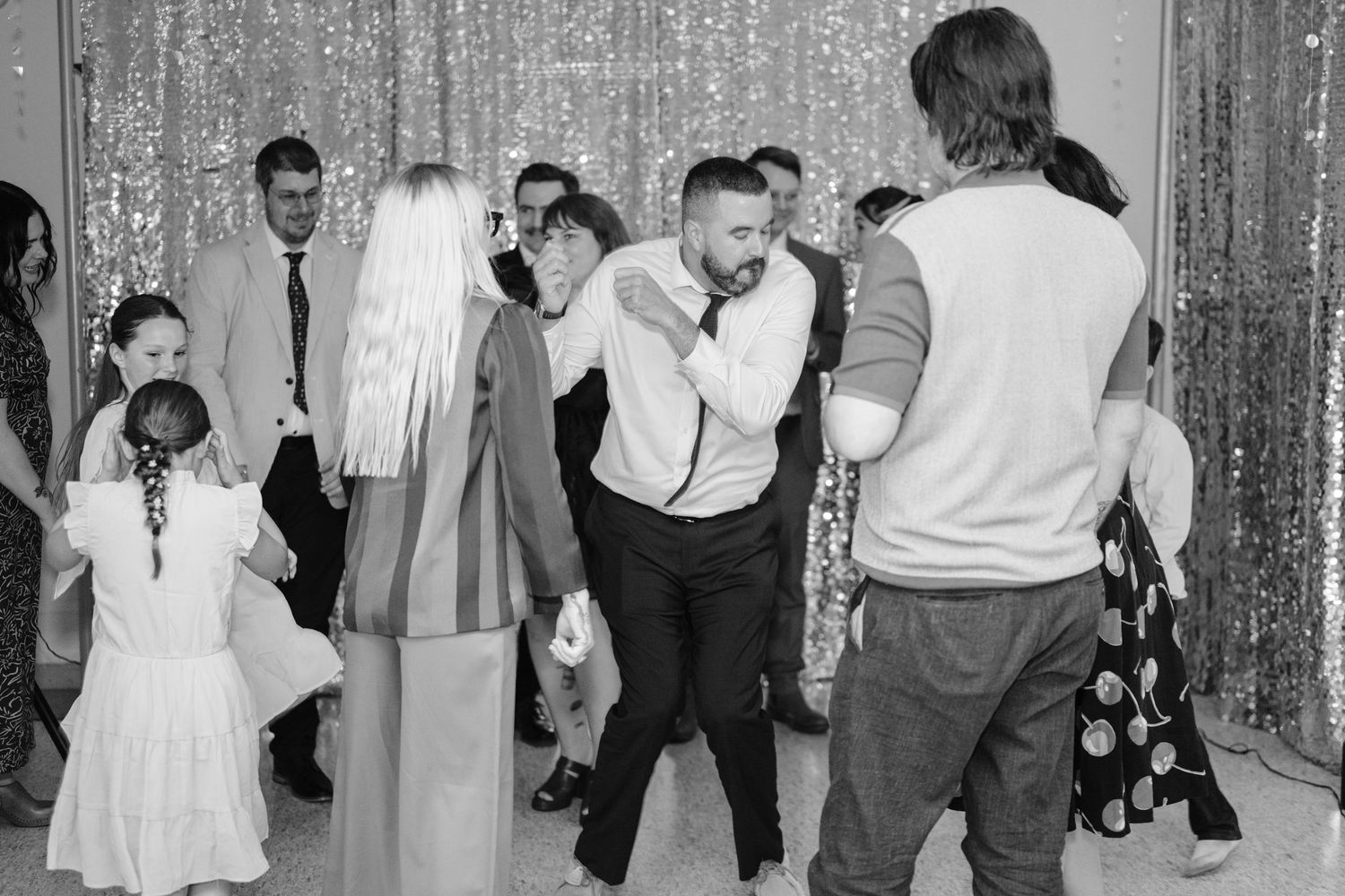 Black and white photos of a wedding reception dance party with silver sequin backdrop.