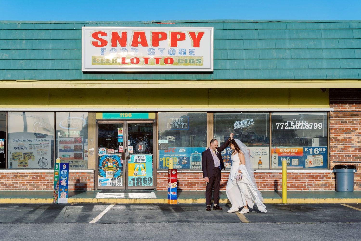 Exterior view of a Snappy convenience store storefront with green awning and brick facade.