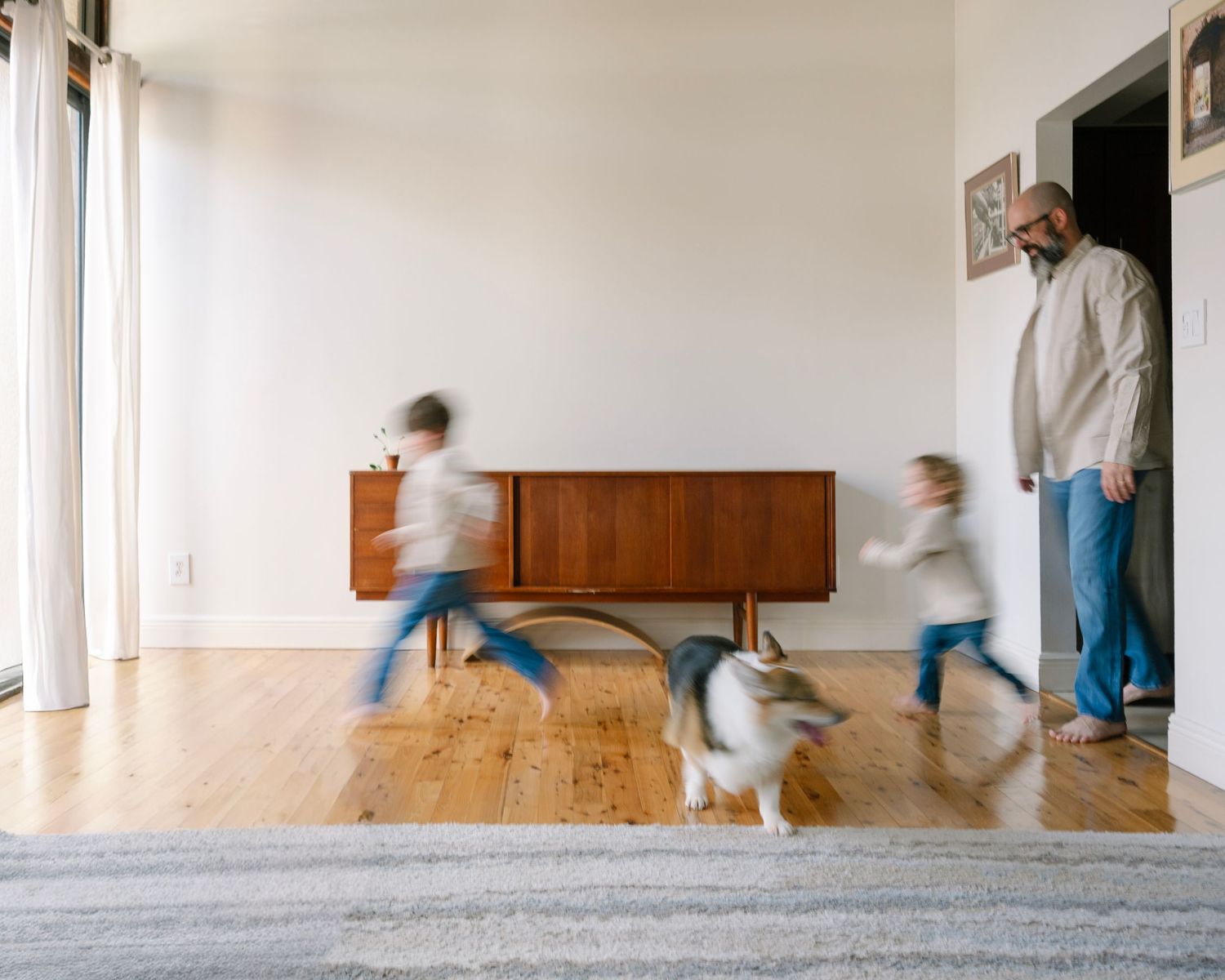 A sequence of motion blur photos showing someone moving furniture up a carpeted staircase.