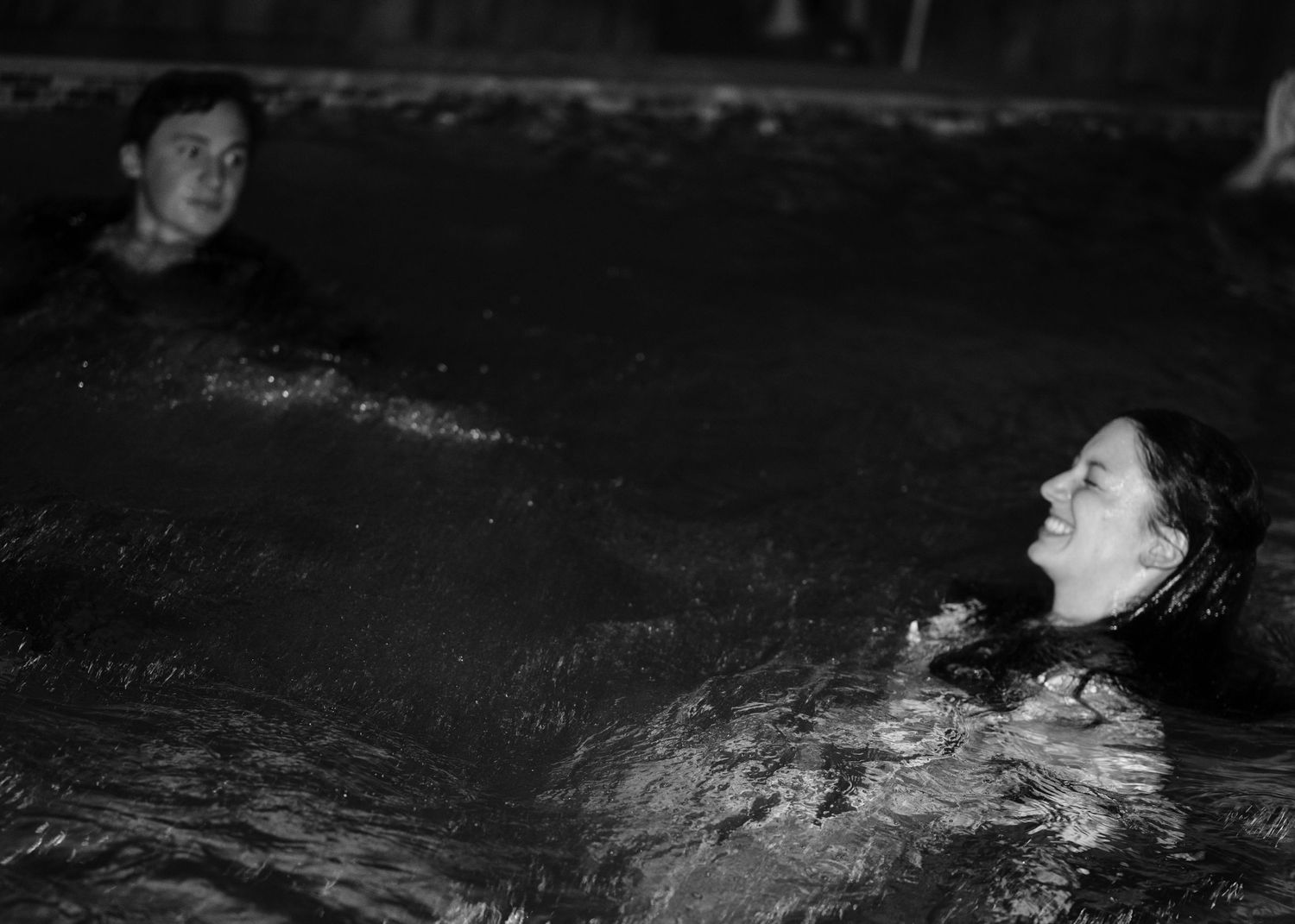 Series of black and white photos showing swimming pool reflections at night.