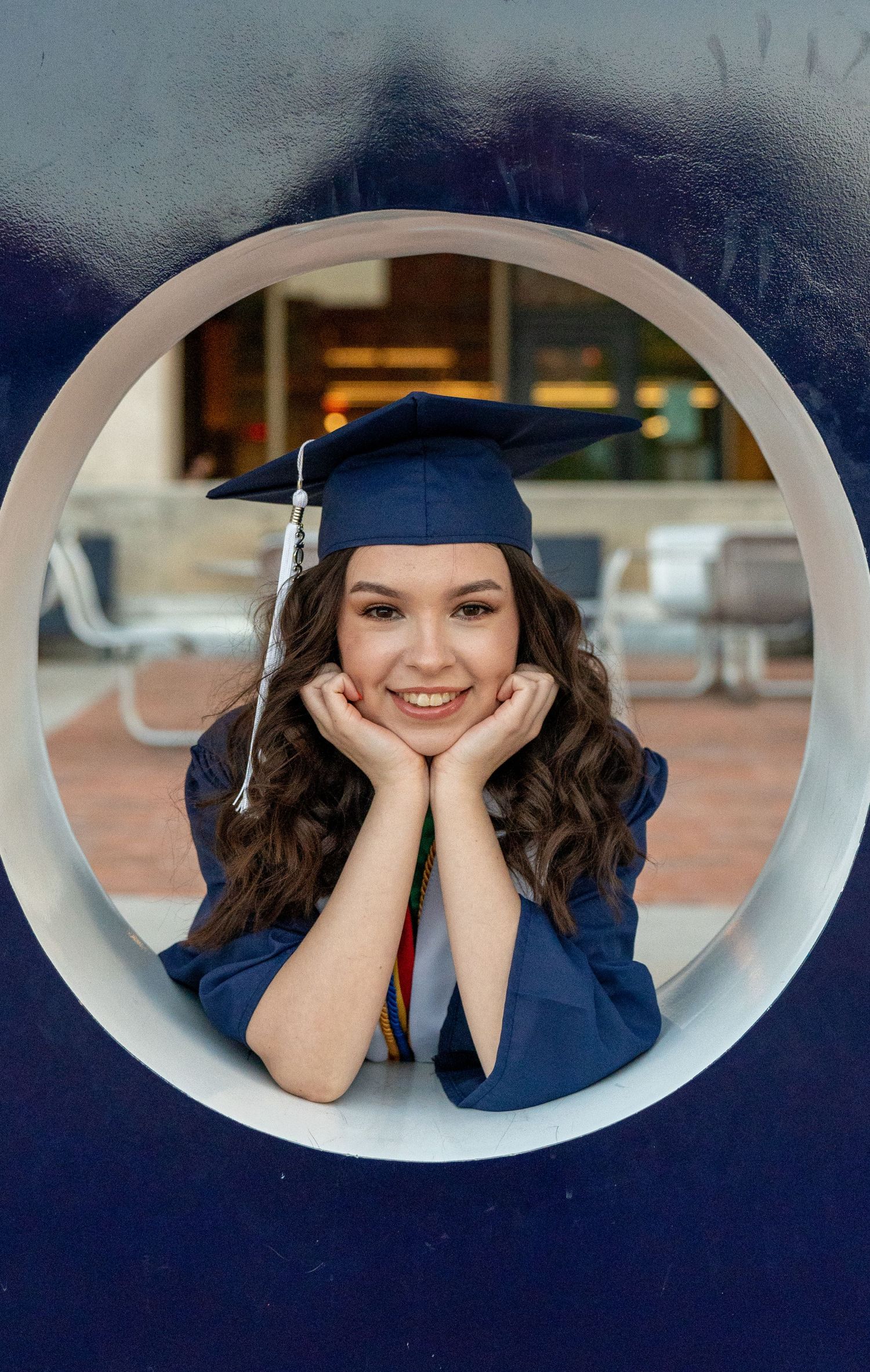 Senior graduation portrait framed inside the Bear Down sign on the University of Arizona campus, photographed by N&D Media.
