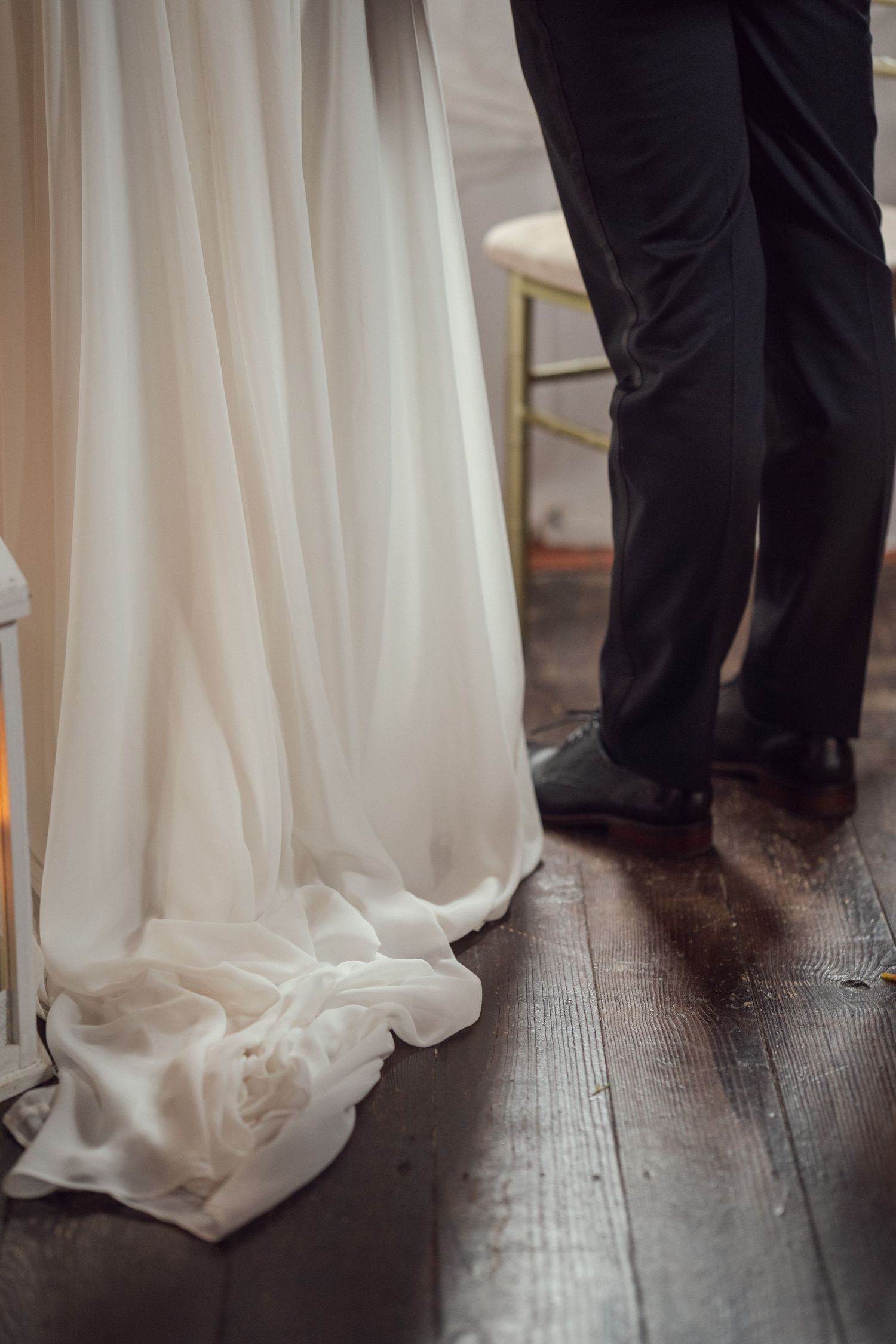 Close-up of flowing white wedding dress train at red chapel Kells in Co Meath.