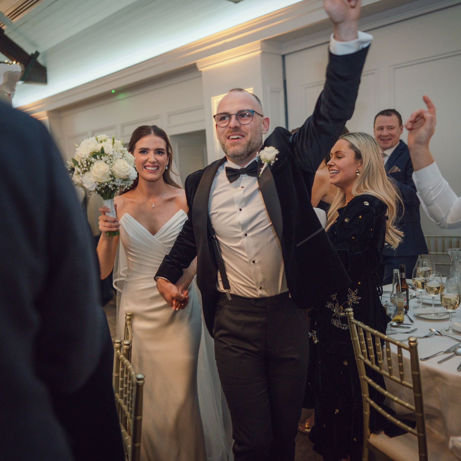 Bride and groom making grand entrance into wedding reception as guests cheer and celebrate at Mount Juliet wedding in Kilkenny.