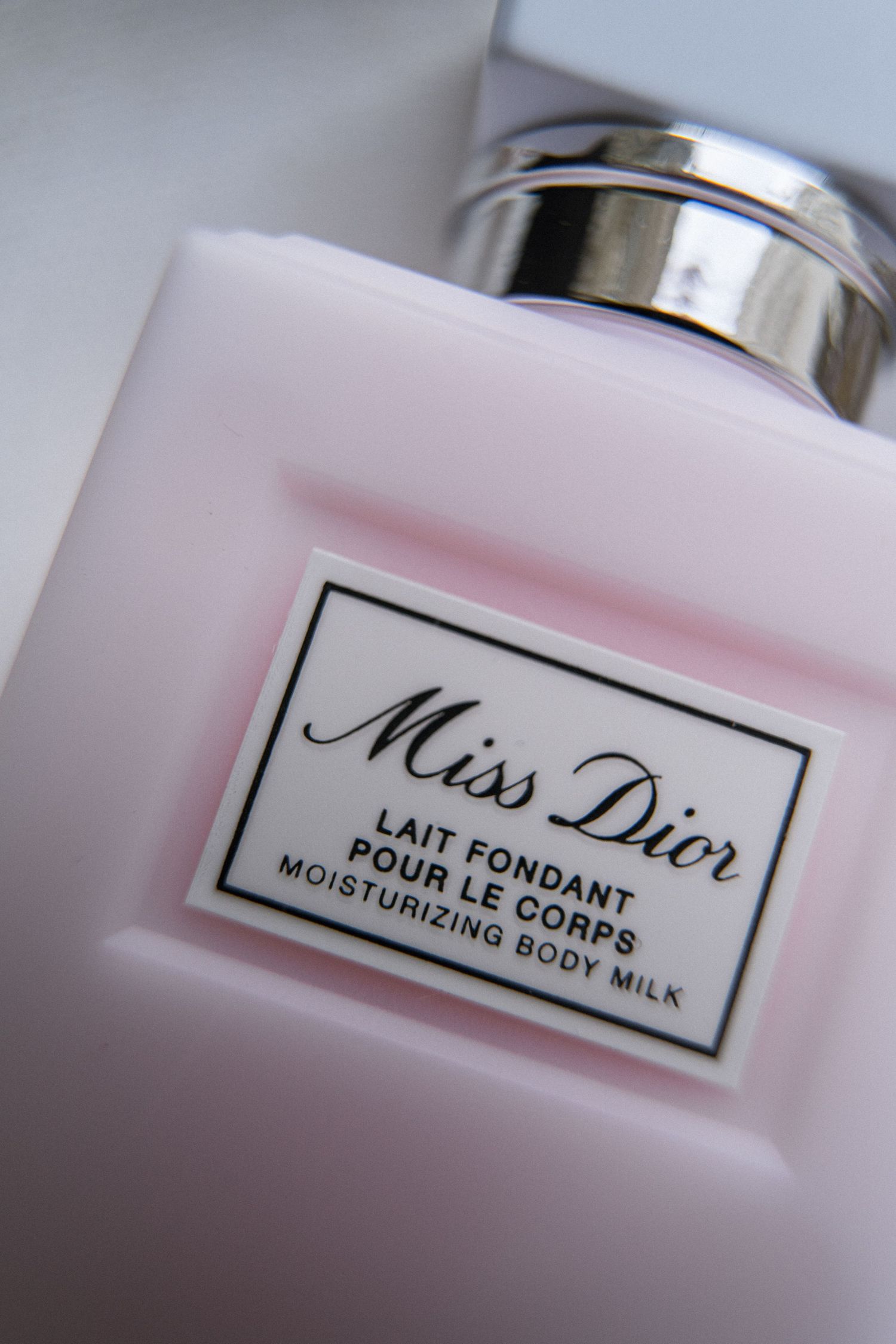 Close-up of Miss Dior Lait Fondant Pour Le Corps moisturizing body milk bottle label.