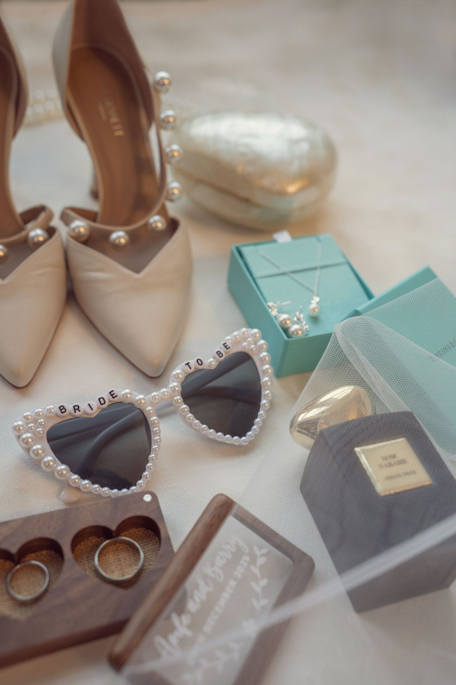 Bridal accessories flatlay with pearl heels, heart sunglasses, rings, & Tiffany jewelry box at the Manor House Mount Juliet wedding Kilkenny