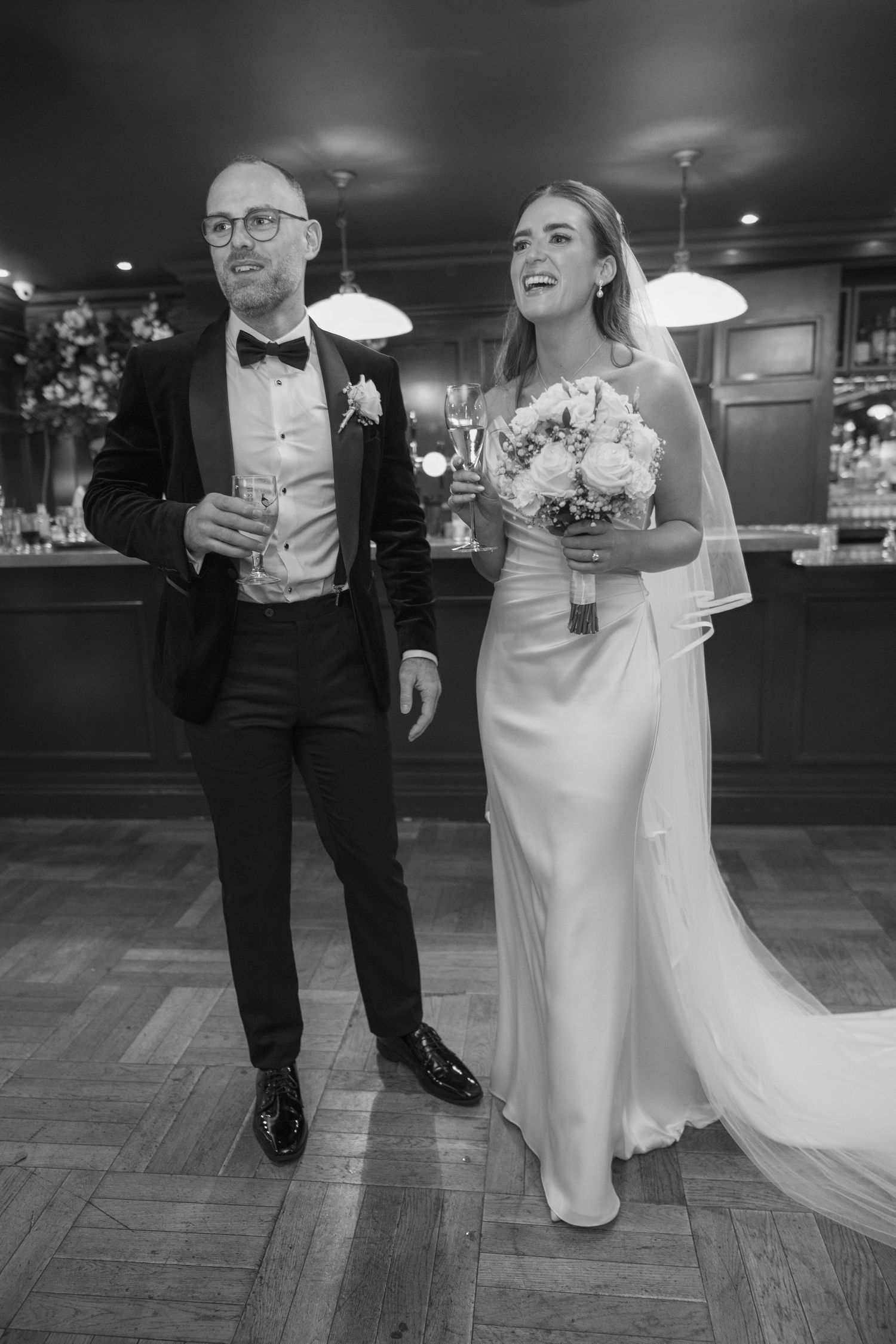 Bride and groom standing together as she holds bouquet at Mount Juliet wedding in Kilkenny.