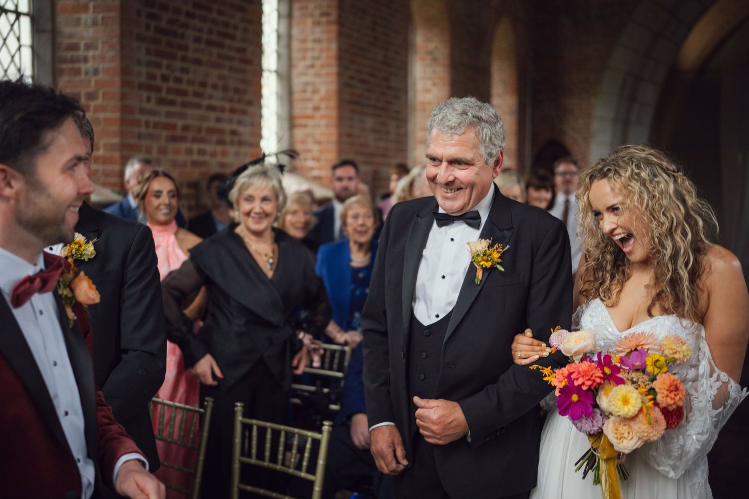 Bride walking down aisle with father at the red chapel in Kells,