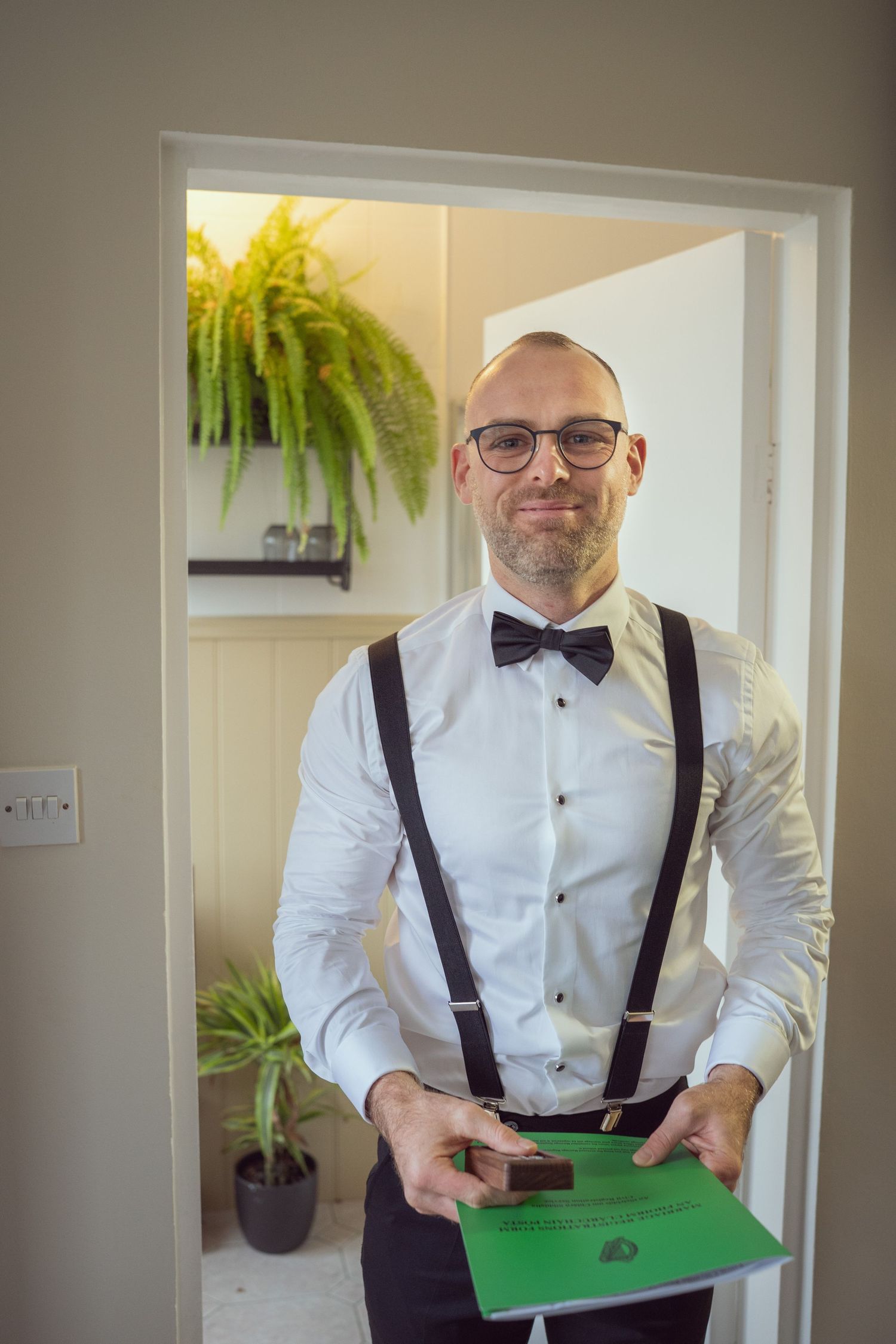 Smiling groom in bow tie and suspenders at the Manor House Mount Juliet wedding Kilkenny.