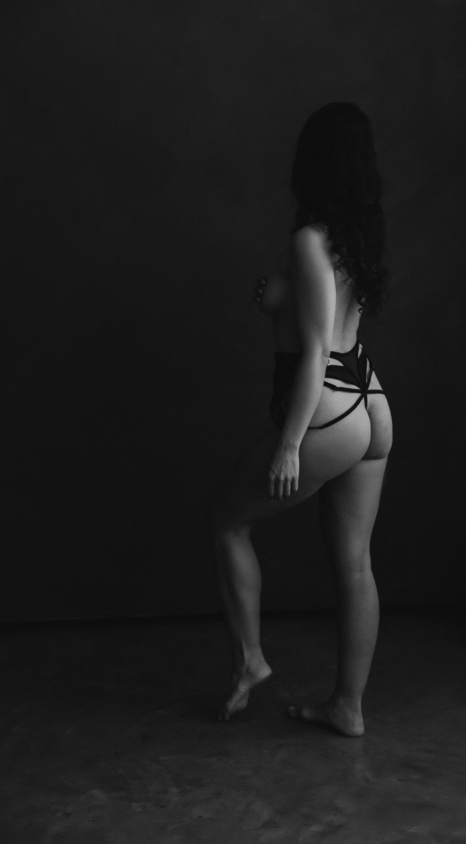 A series of black and white artistic nude photographs showing silhouetted figures in dramatic poses against a dark background.