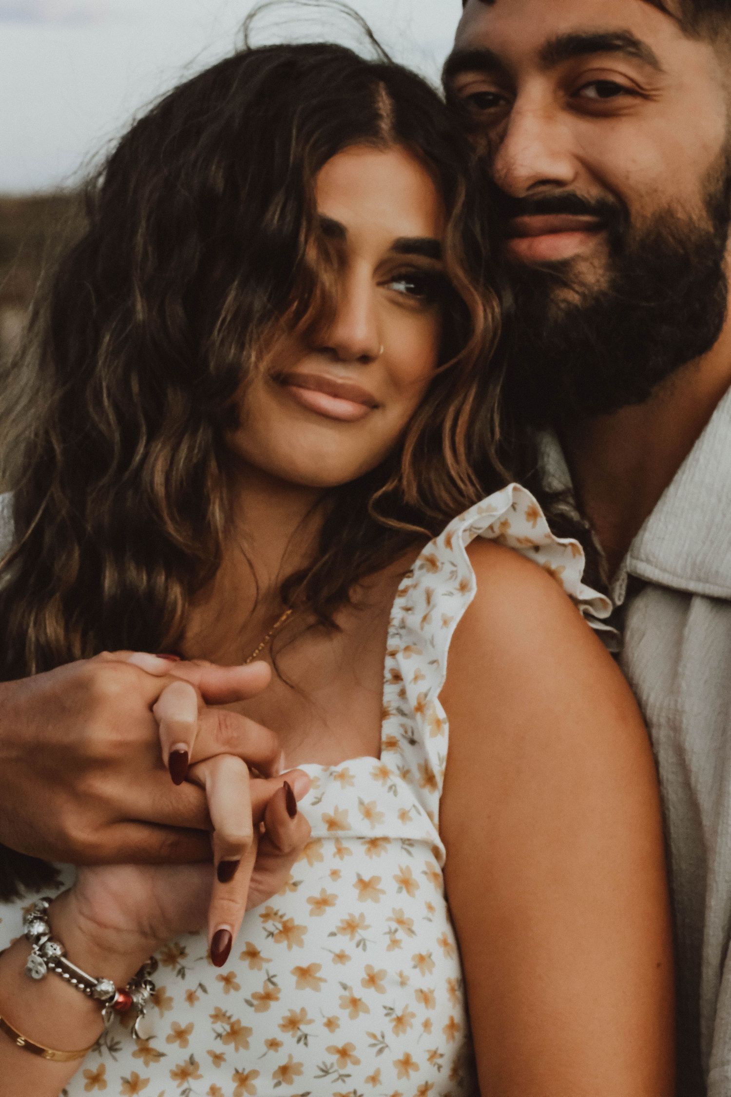 A romantic couple shares intimate moments in a series of warm-toned photographs showing affection and closeness.
