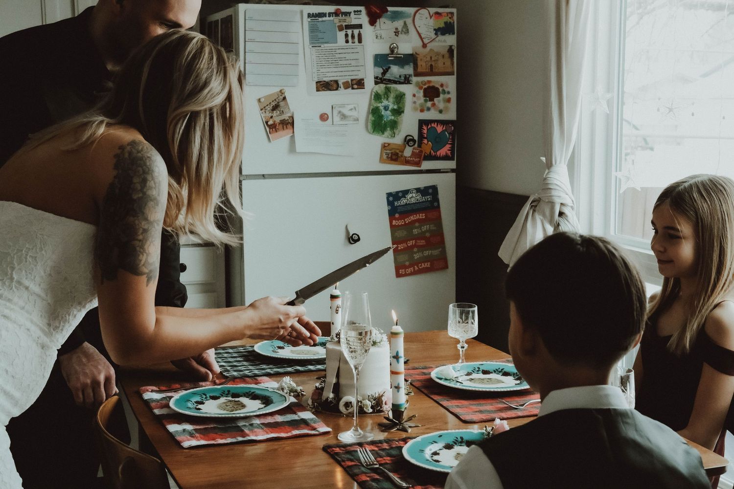 People sitting at a dining table sharing a meal together in a cozy home setting.