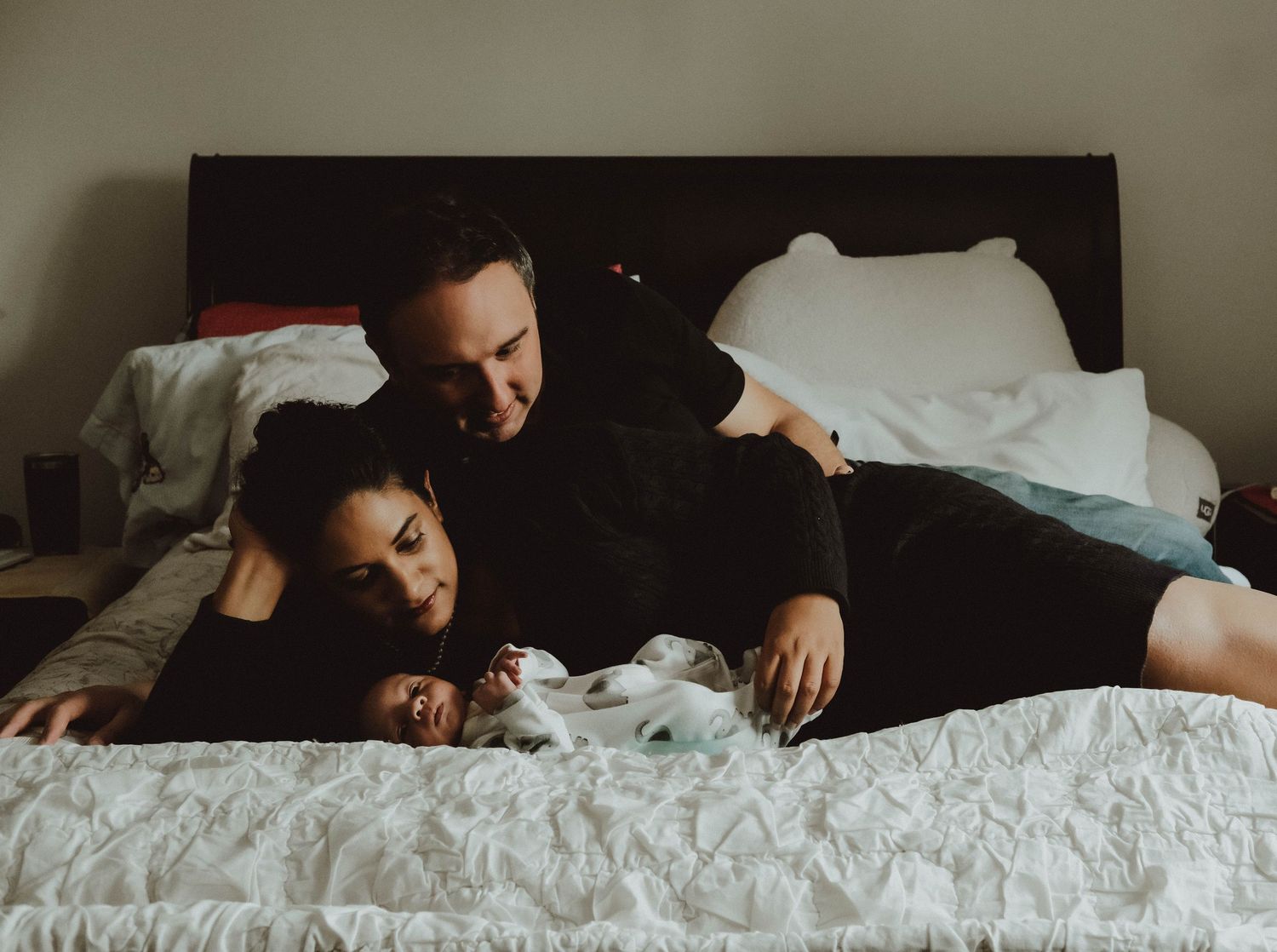 A sequence of photos showing someone sleeping in bed with white bedding and pillows.