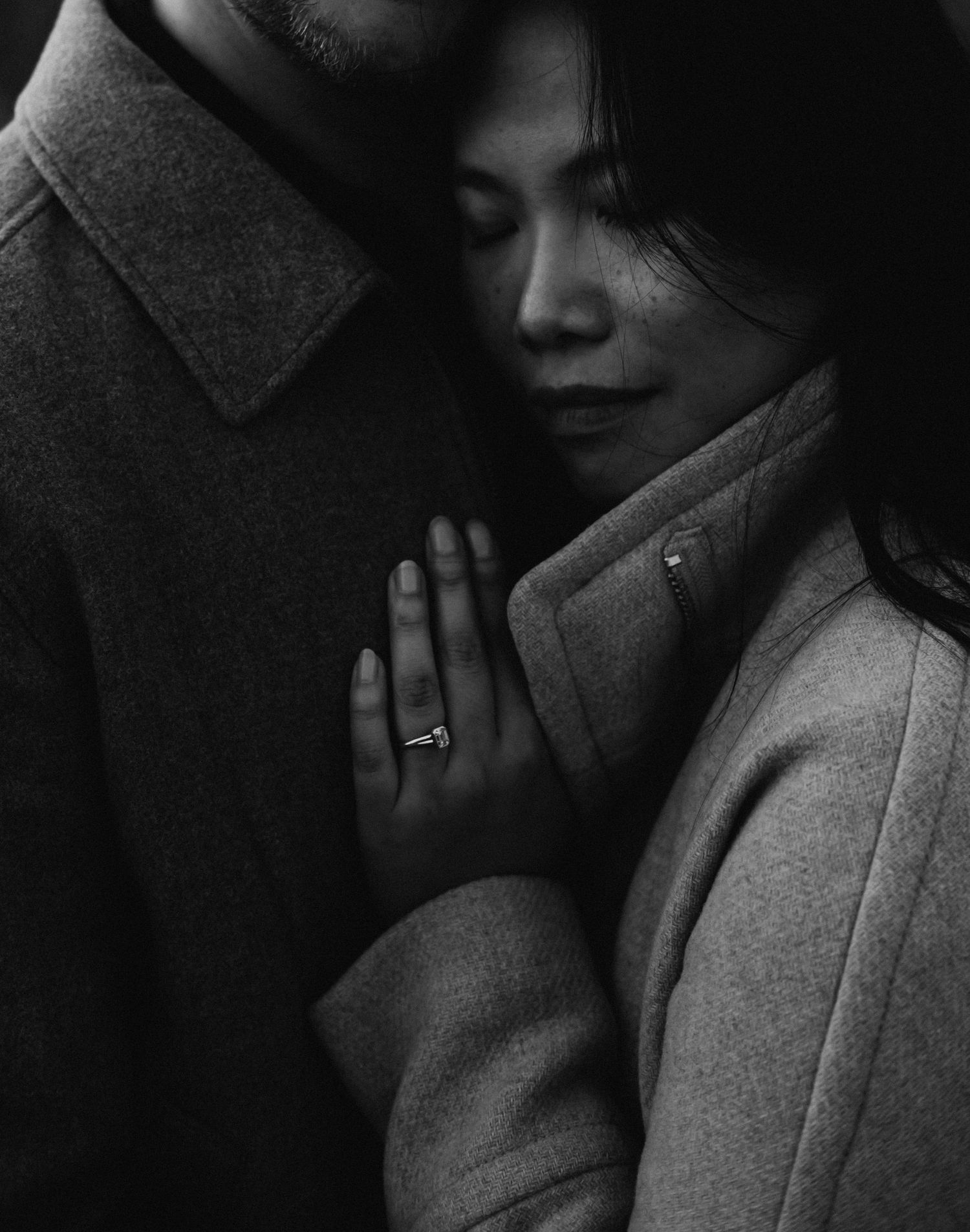 Intimate black and white photo series showing tender moments between two people in dark lighting.