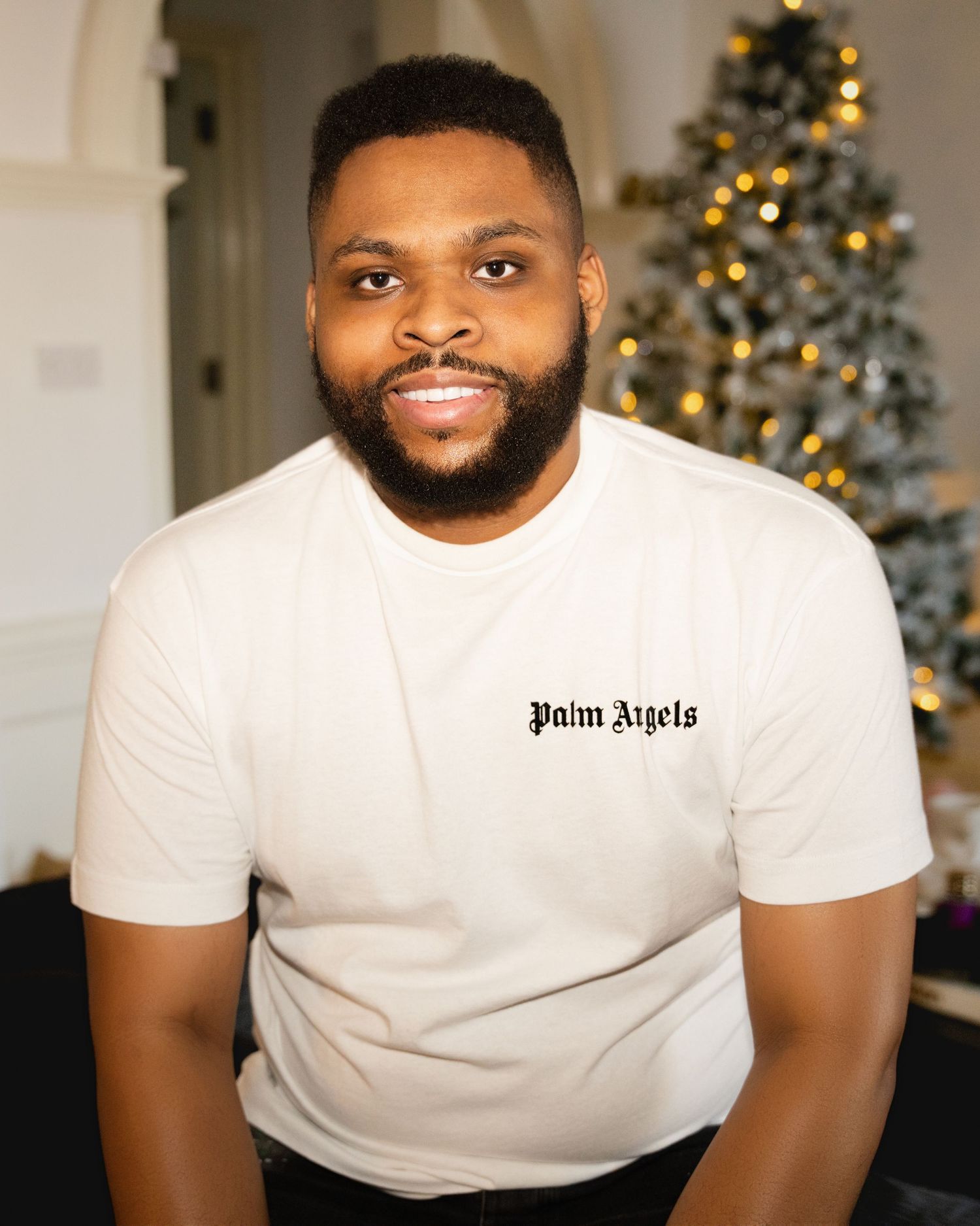 Holiday themed portrait series with decorated Christmas trees in background.