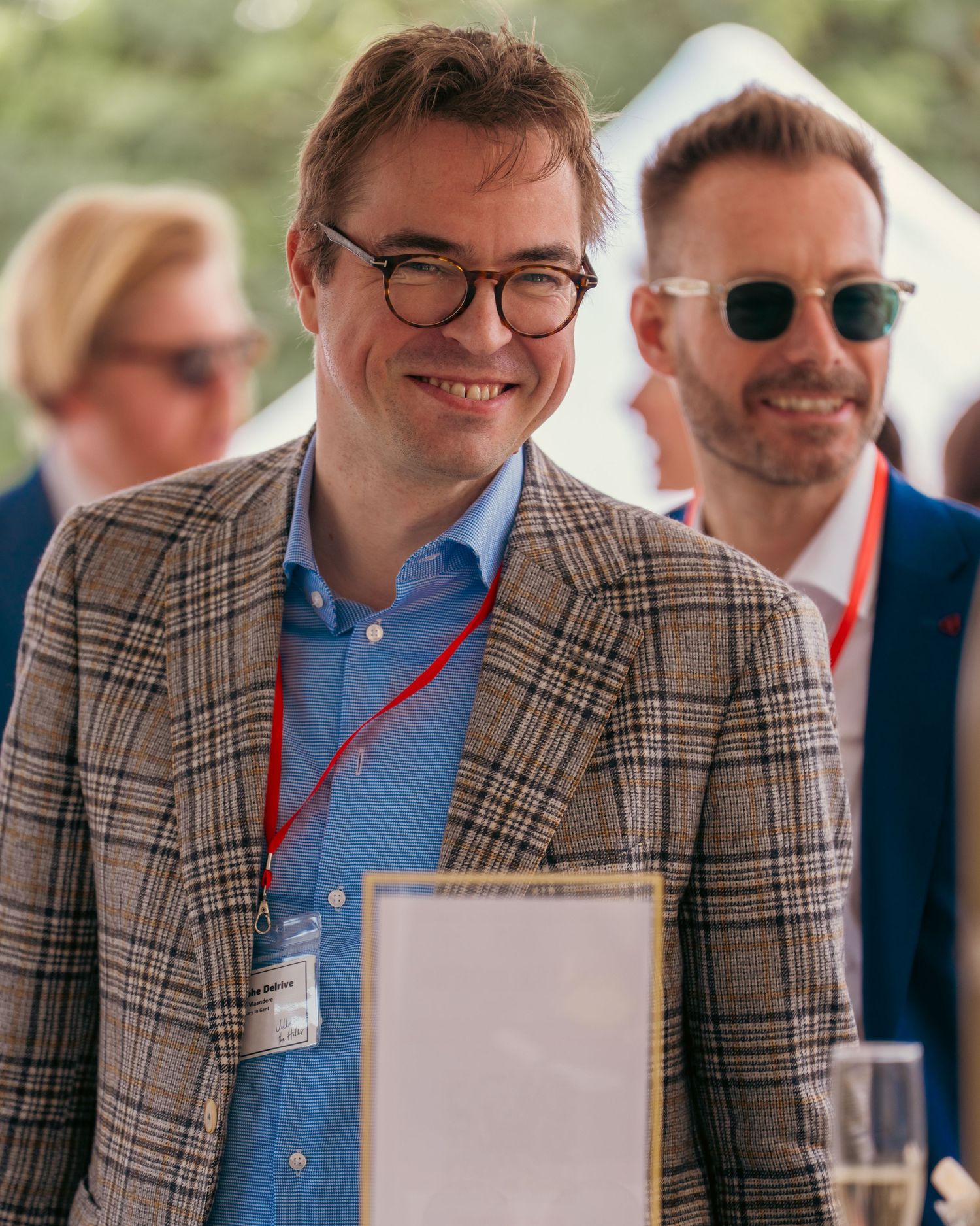 Guests in plaid blazers and business attire at networking event.