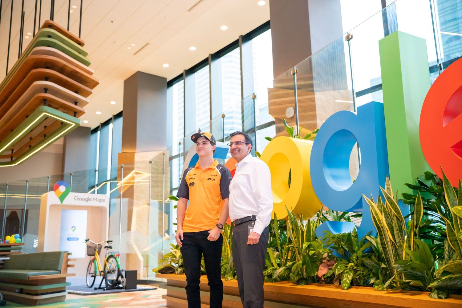 Modern office interior with colorful Google logo and glass windows.