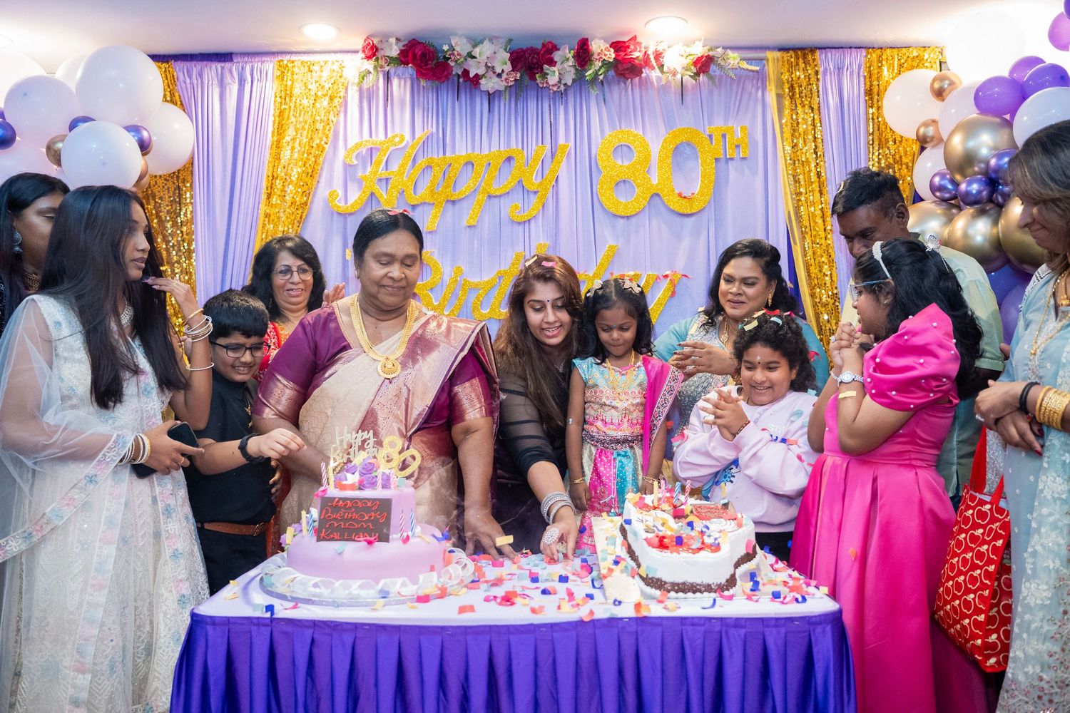 Colorful birthday party decorations with balloons, streamers and a cake table setup for a festive celebration.