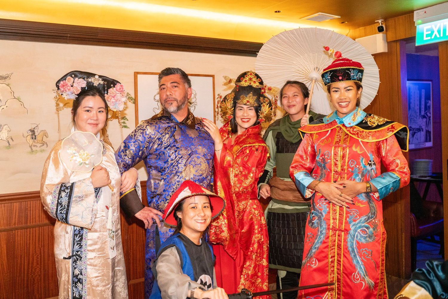 People wearing traditional Chinese costumes at a cultural celebration.