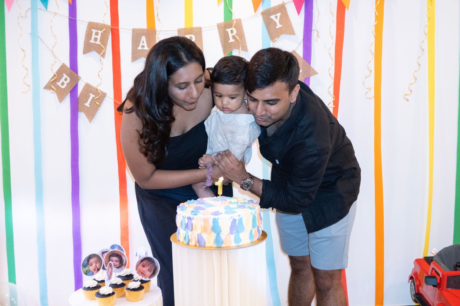 Birthday celebration setup with rainbow streamers and festive party decorations.
