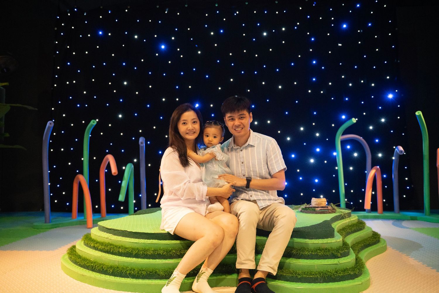 Starlit backdrop with green seating area creating a magical atmosphere.