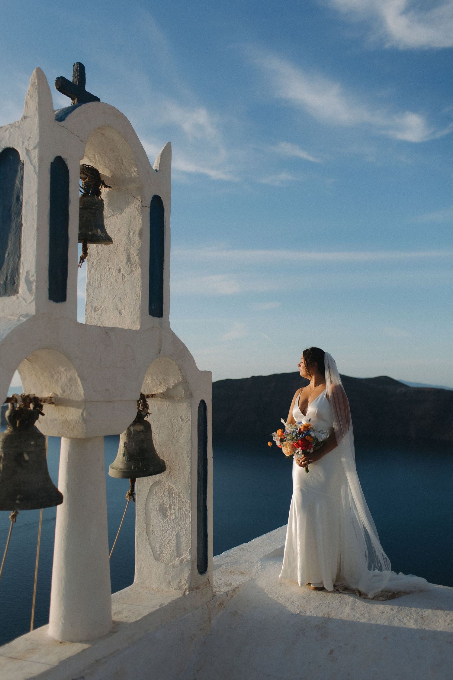 Wedding photography session on white steps overlooking the blue Mediterranean Sea.