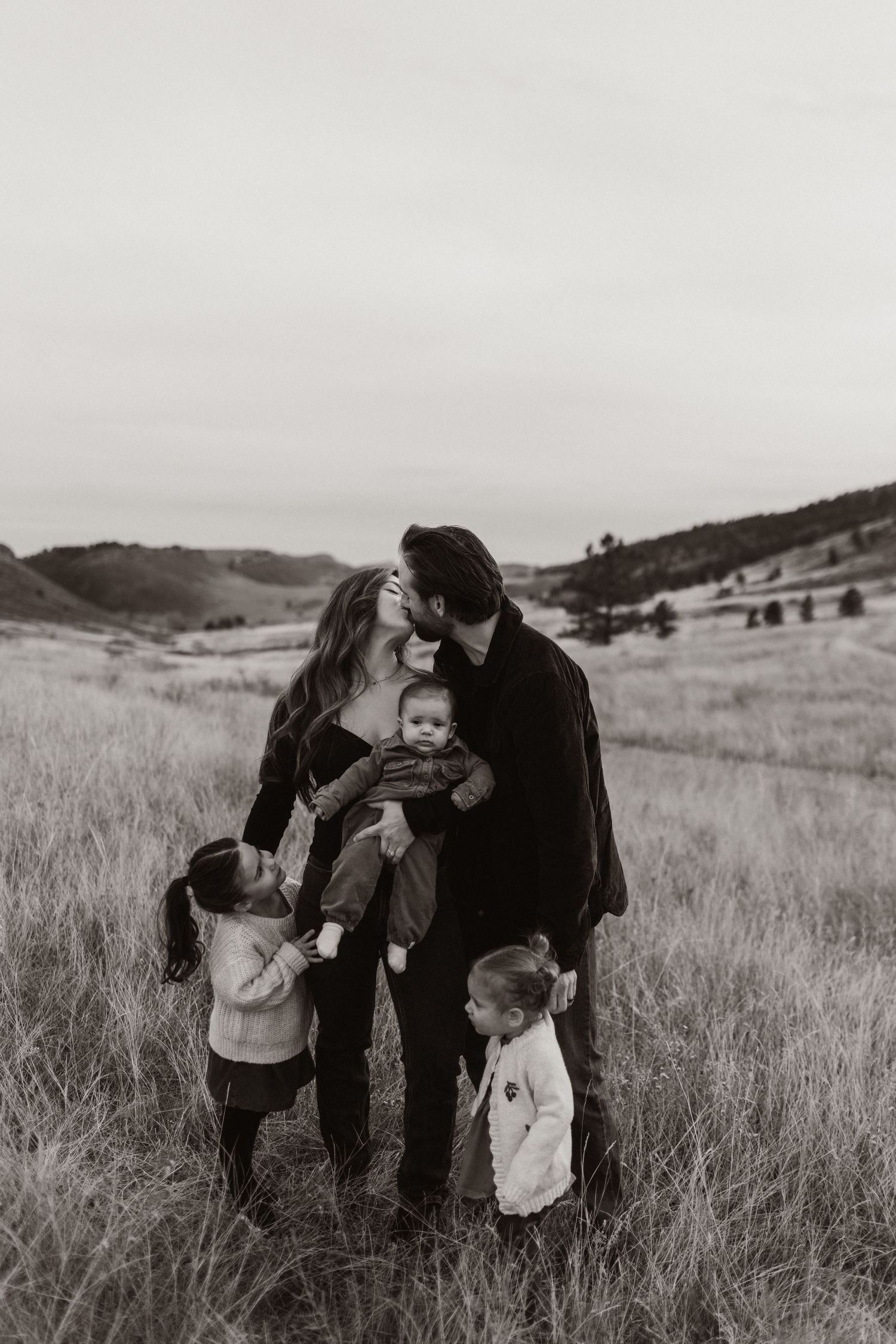 Black and white family photography session in a scenic mountain meadow.