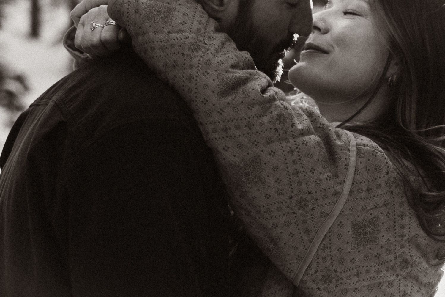 Intimate black and white close-up portraits of couple sharing tender moments.