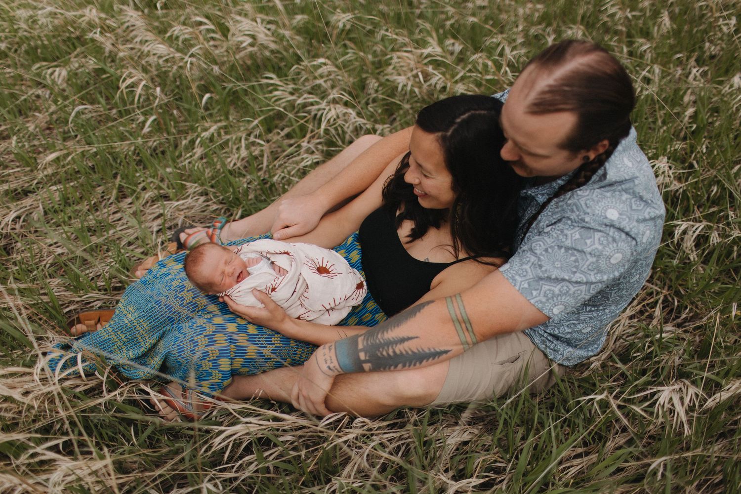 Intimate outdoor photo series showing tender moments in tall grass.