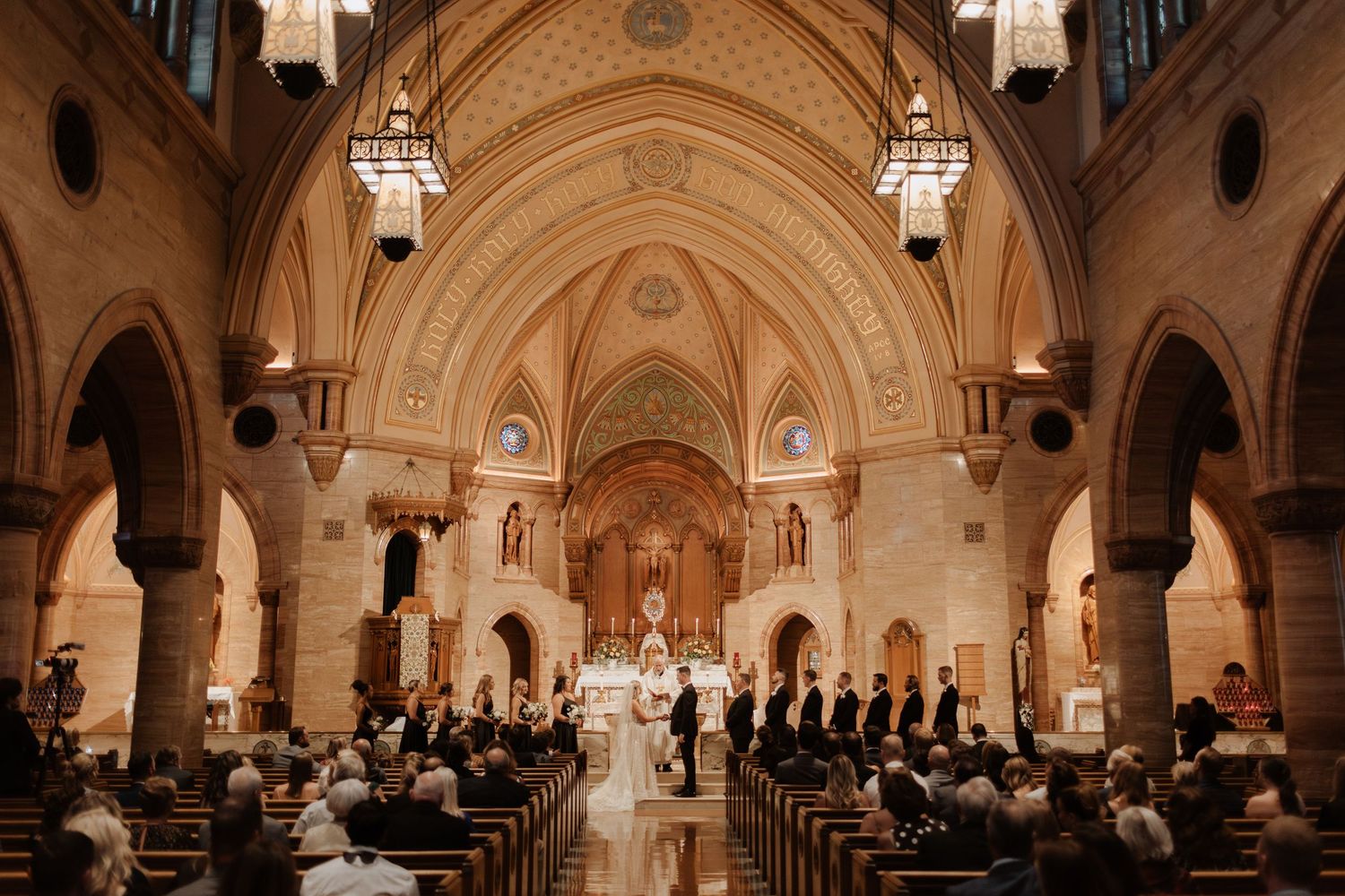 Panoramic view of an ornate church interior with vaulted ceilings and gothic architecture.