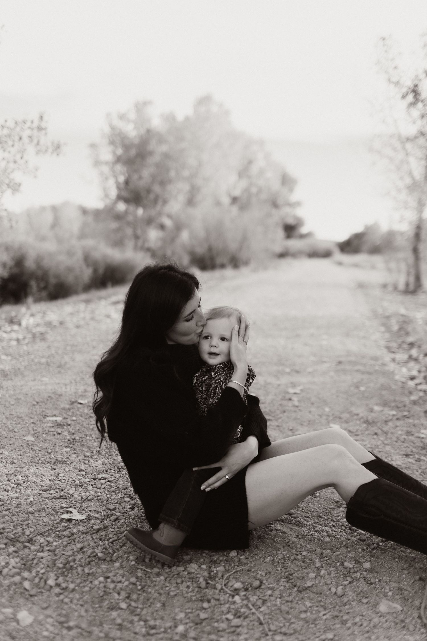 Black and white artistic photos of two people lying on the ground in an intimate pose.