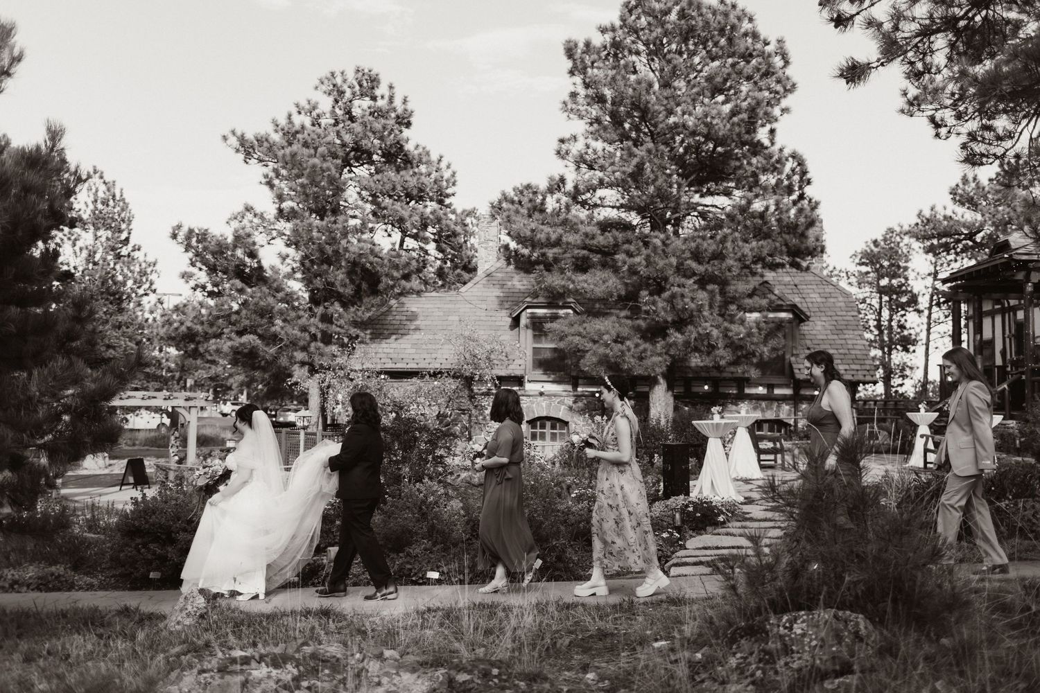 Vintage panoramic photograph showing people gathered in a wooded outdoor setting.