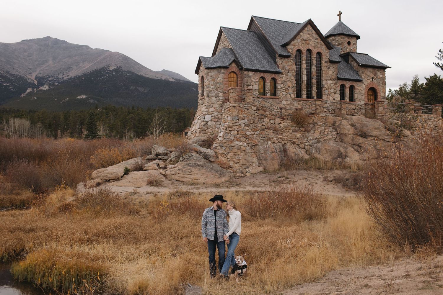 Historic stone church photographed in a mountain landscape with dramatic autumn scenery.