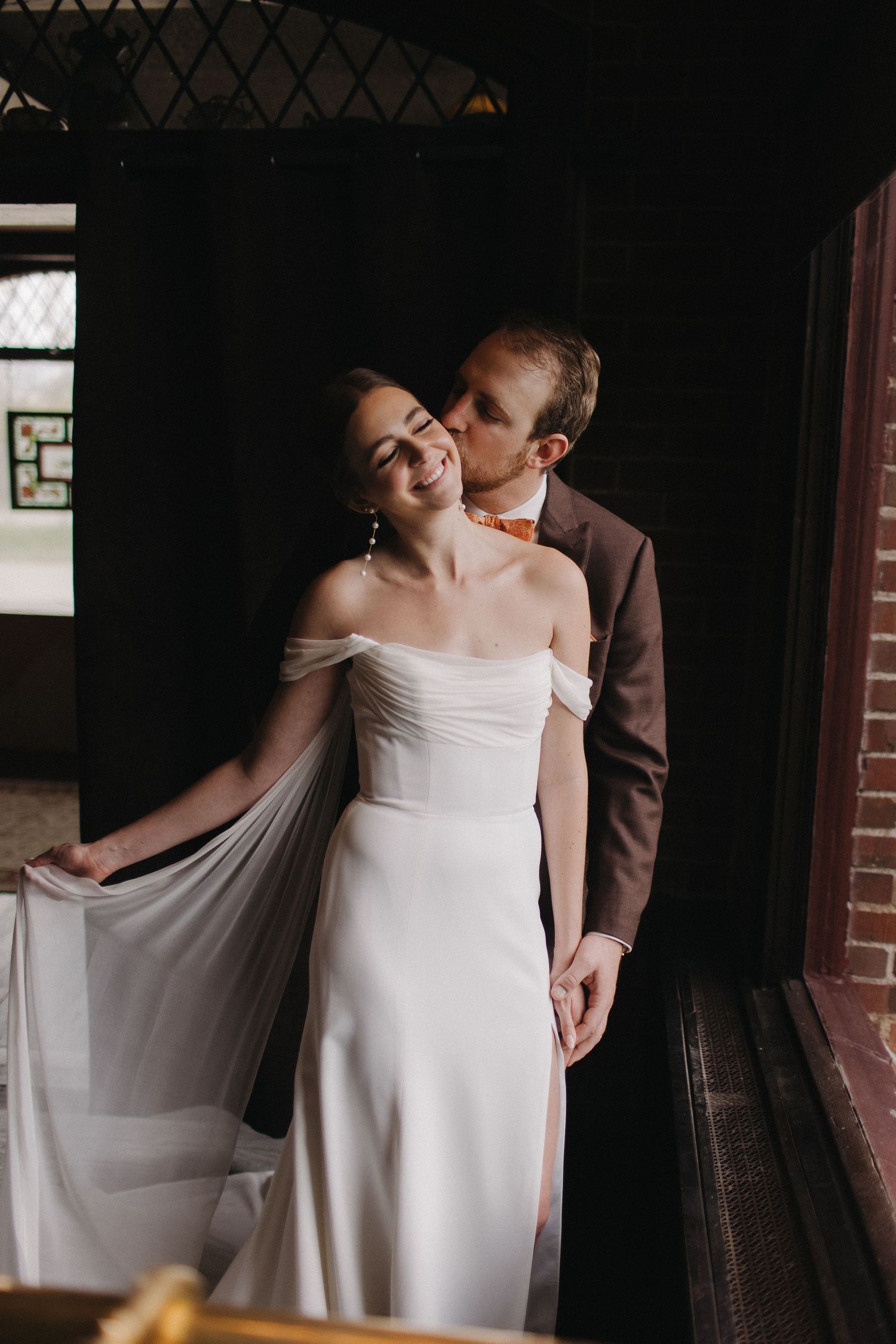 Intimate wedding moments captured in a dark indoor setting with natural light.