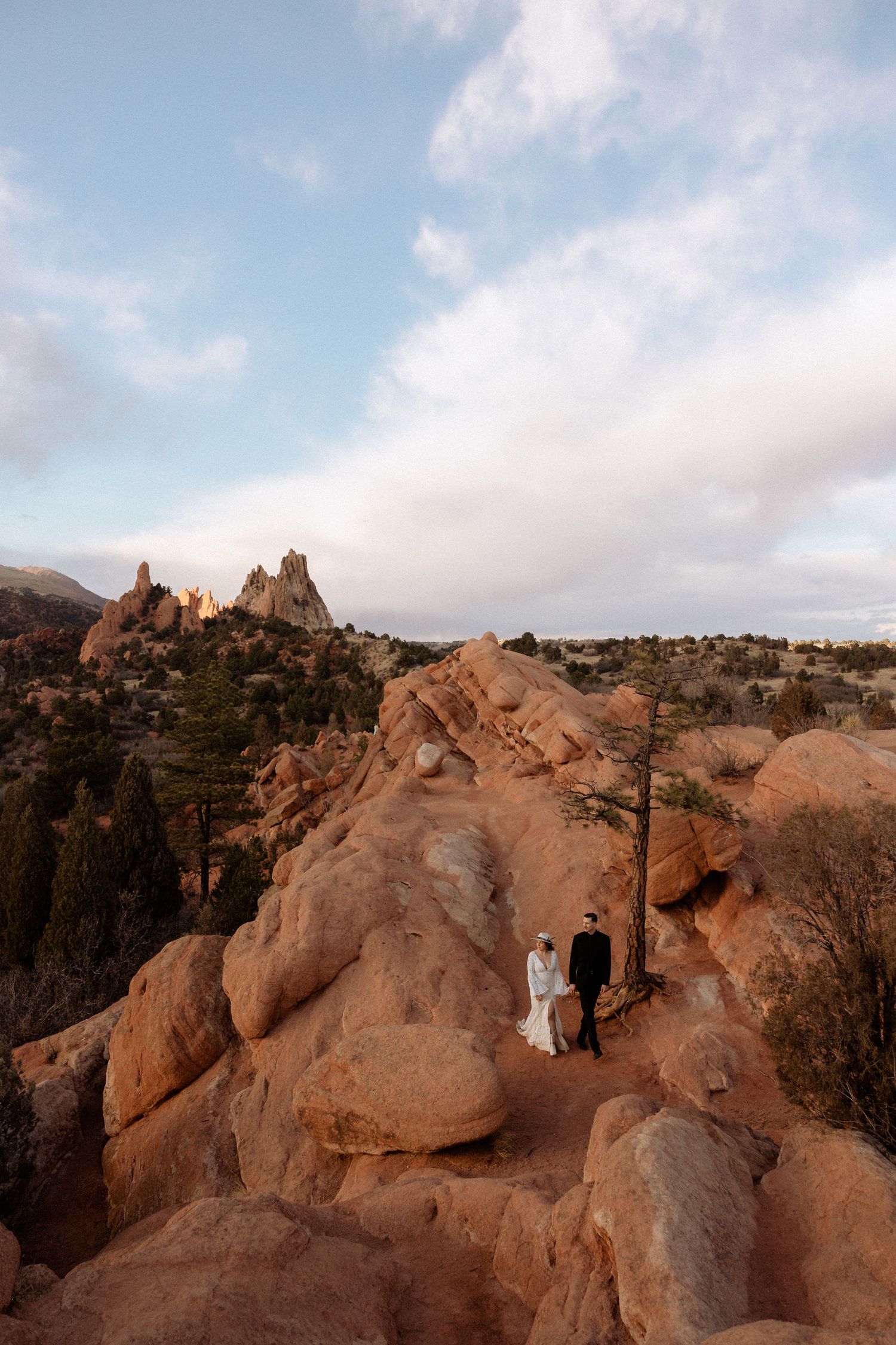 Scenic wedding photos captured against red rock formations during golden hour.