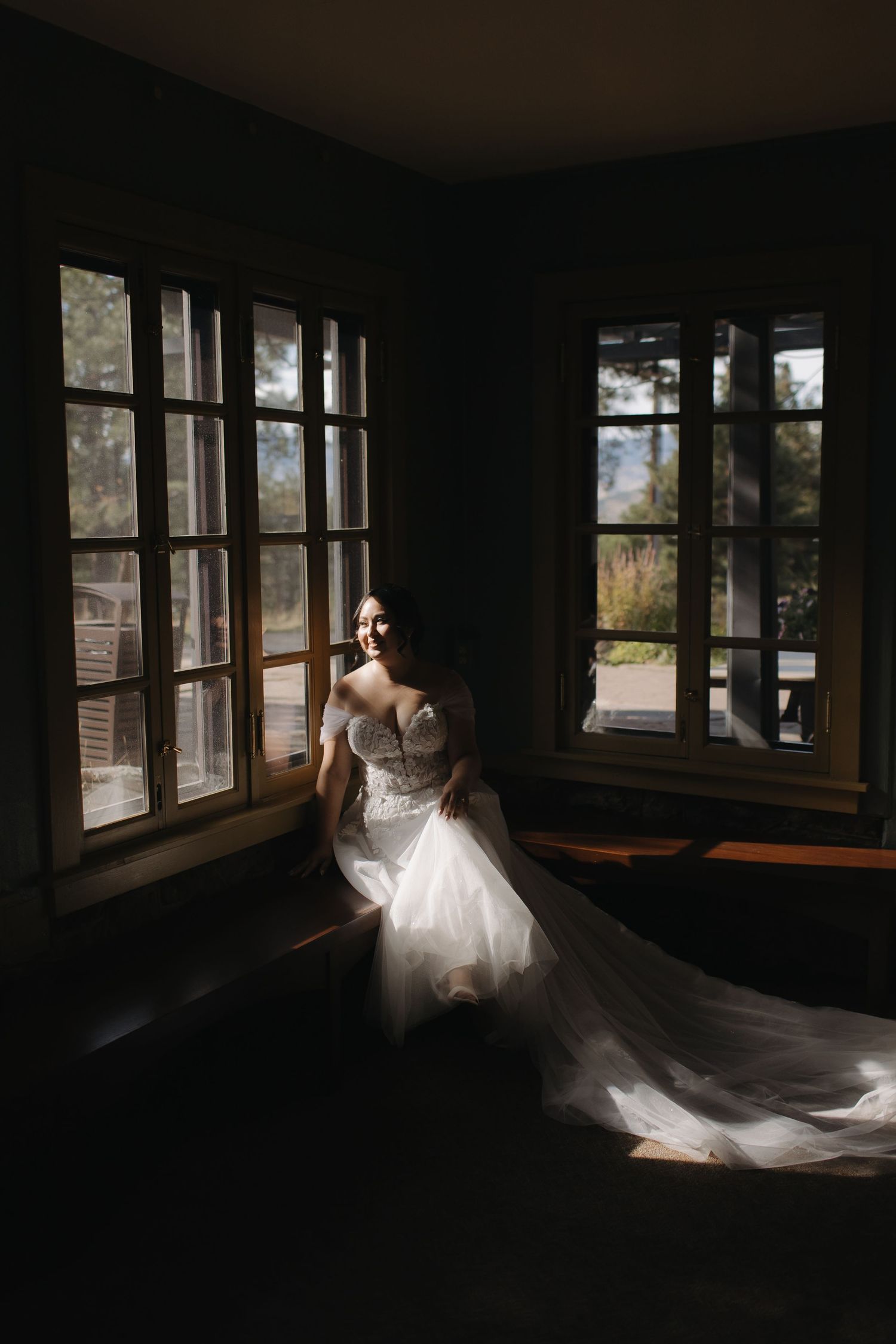 Dramatic sequence of white dress flowing in dark room with window light.