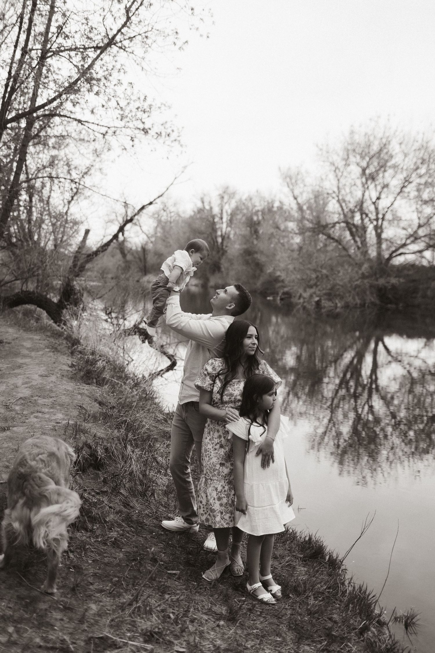 Black and white photos of people enjoying a day by a tranquil pond with trees in the background.