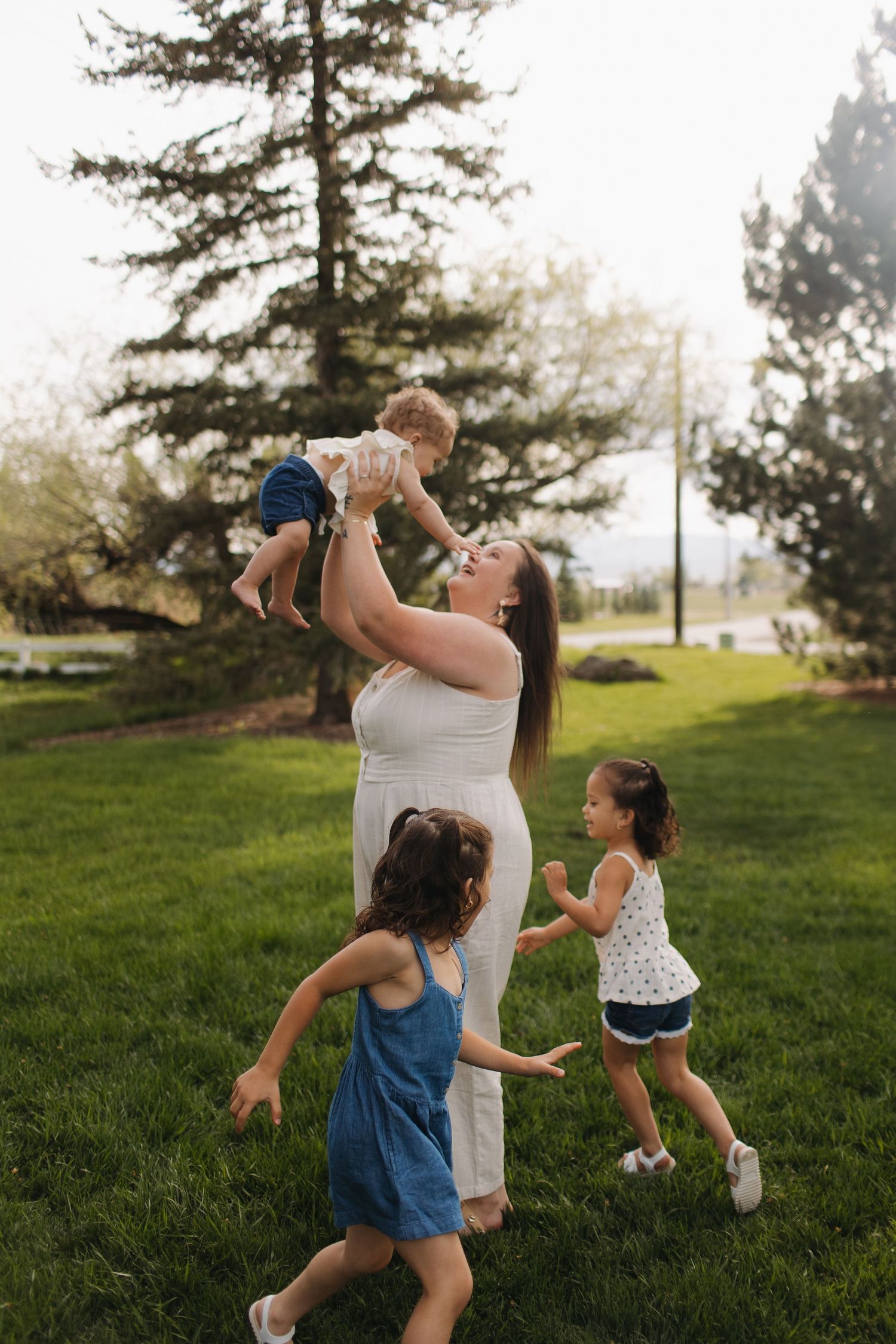 Joyful outdoor scene with children playing and running around in grassy park.