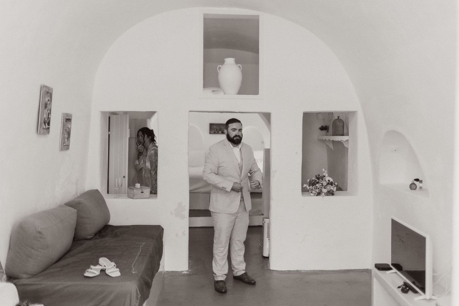 Interior shots of a minimalist white space with arched doorways and natural light.