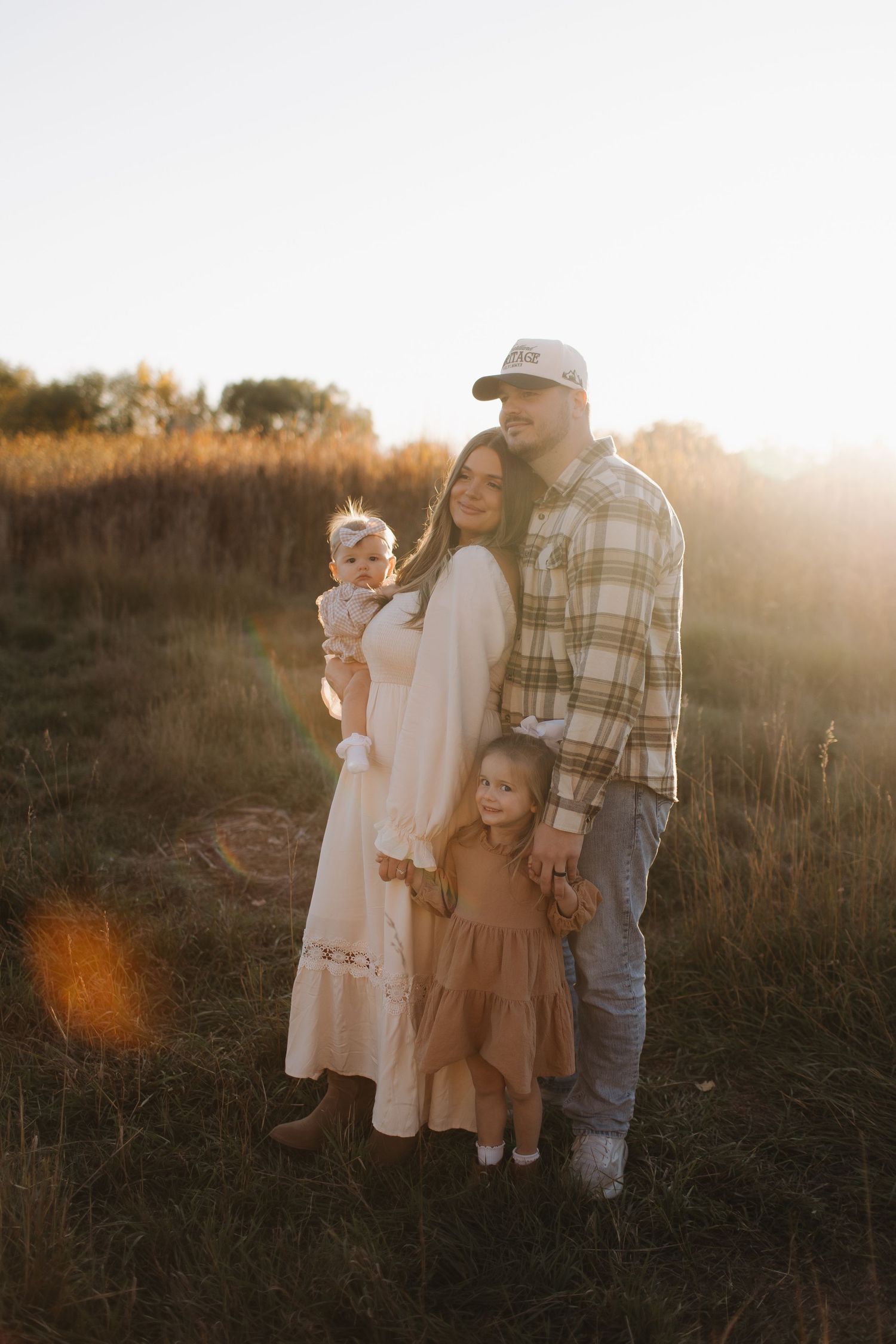 Family enjoying a sunset moment together in a rustic outdoor setting.