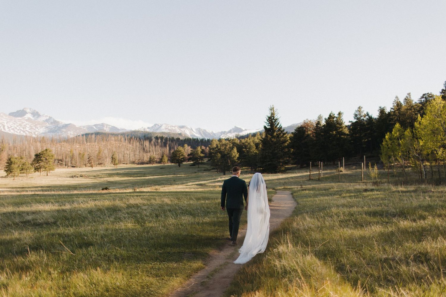 Scenic mountain landscape panorama with wedding couple in the distance.