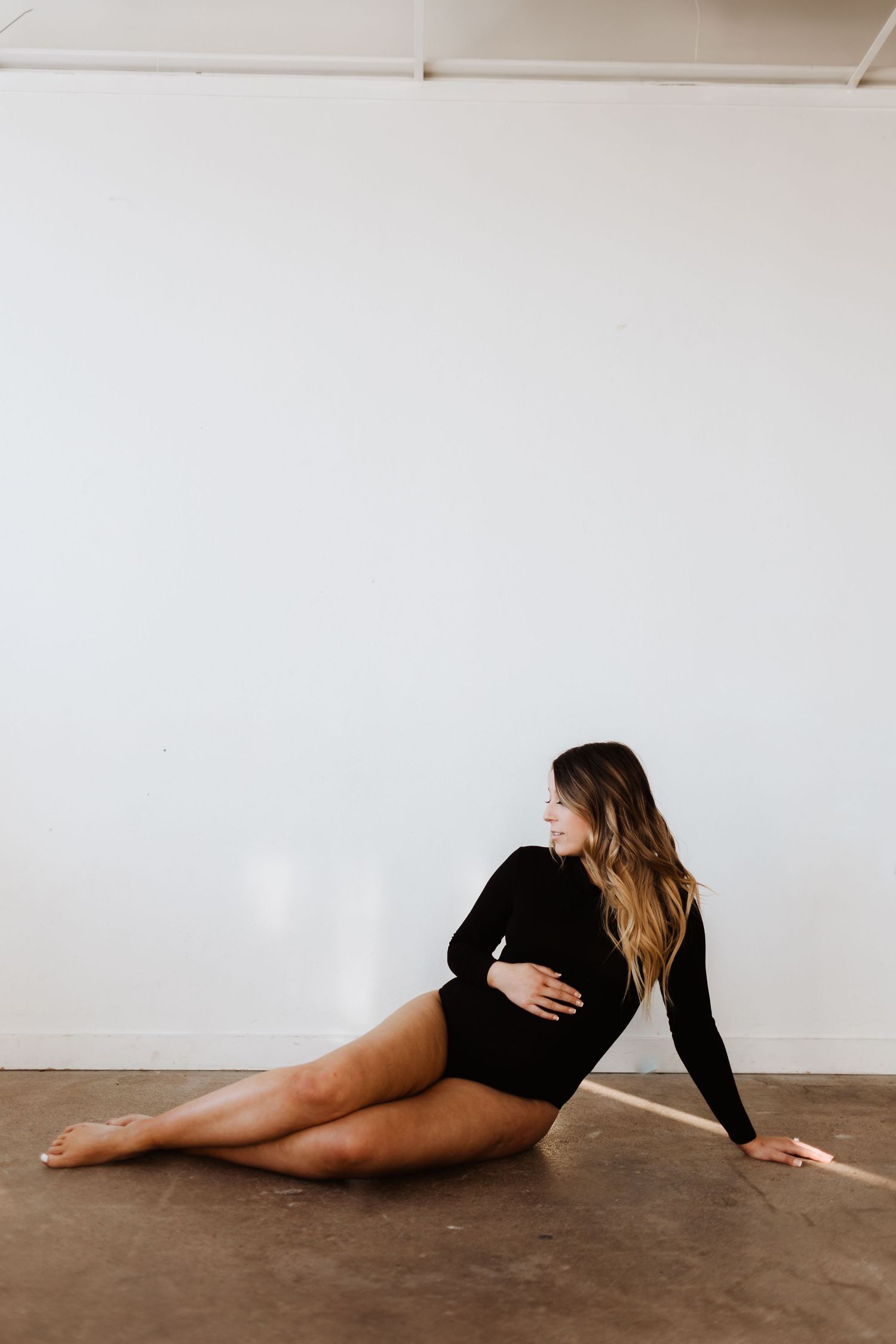 Artistic black and white photo series showing a figure reclining against a wall in different poses.