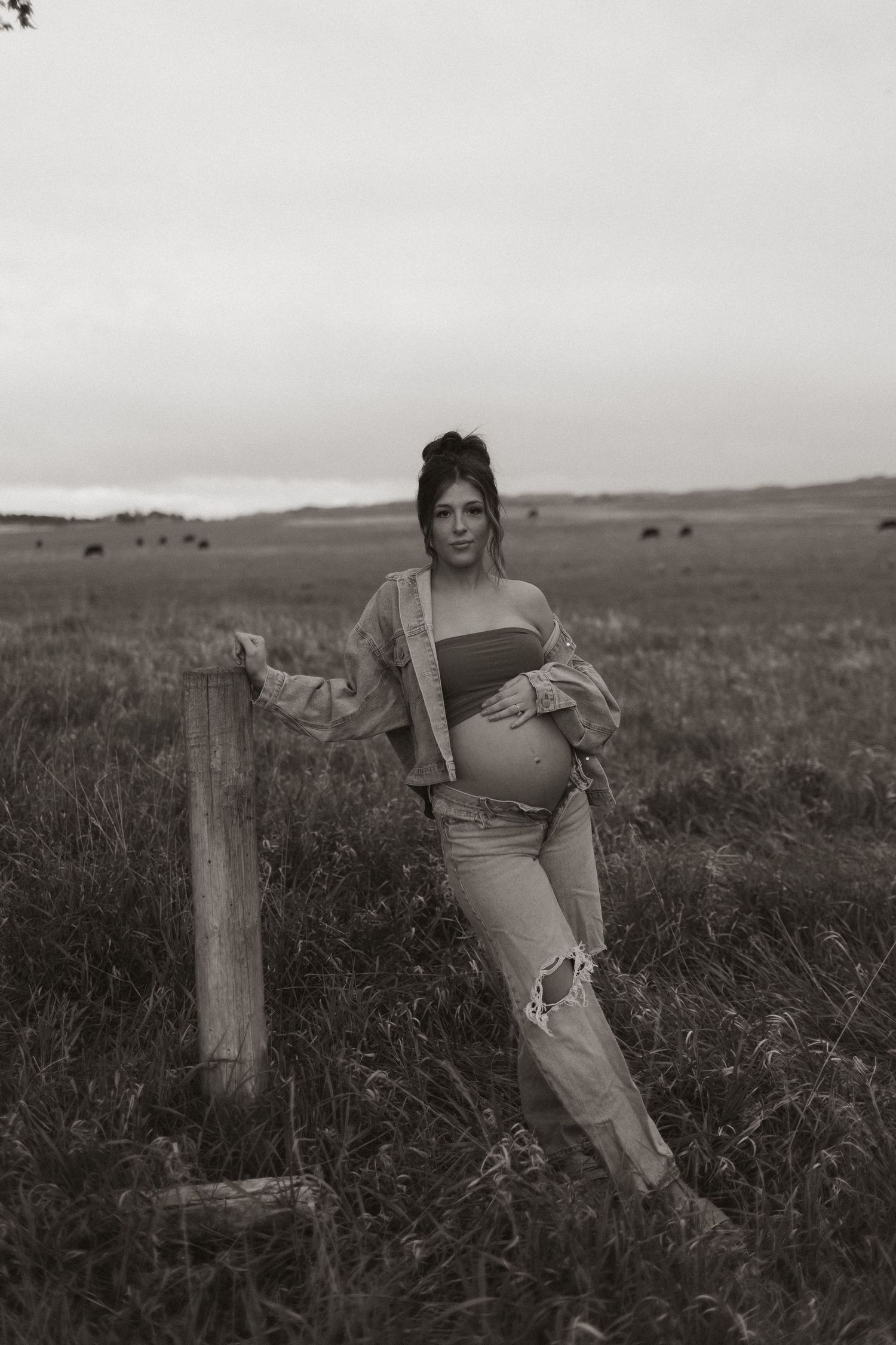 Artistic black and white portraits taken in a rustic prairie landscape.