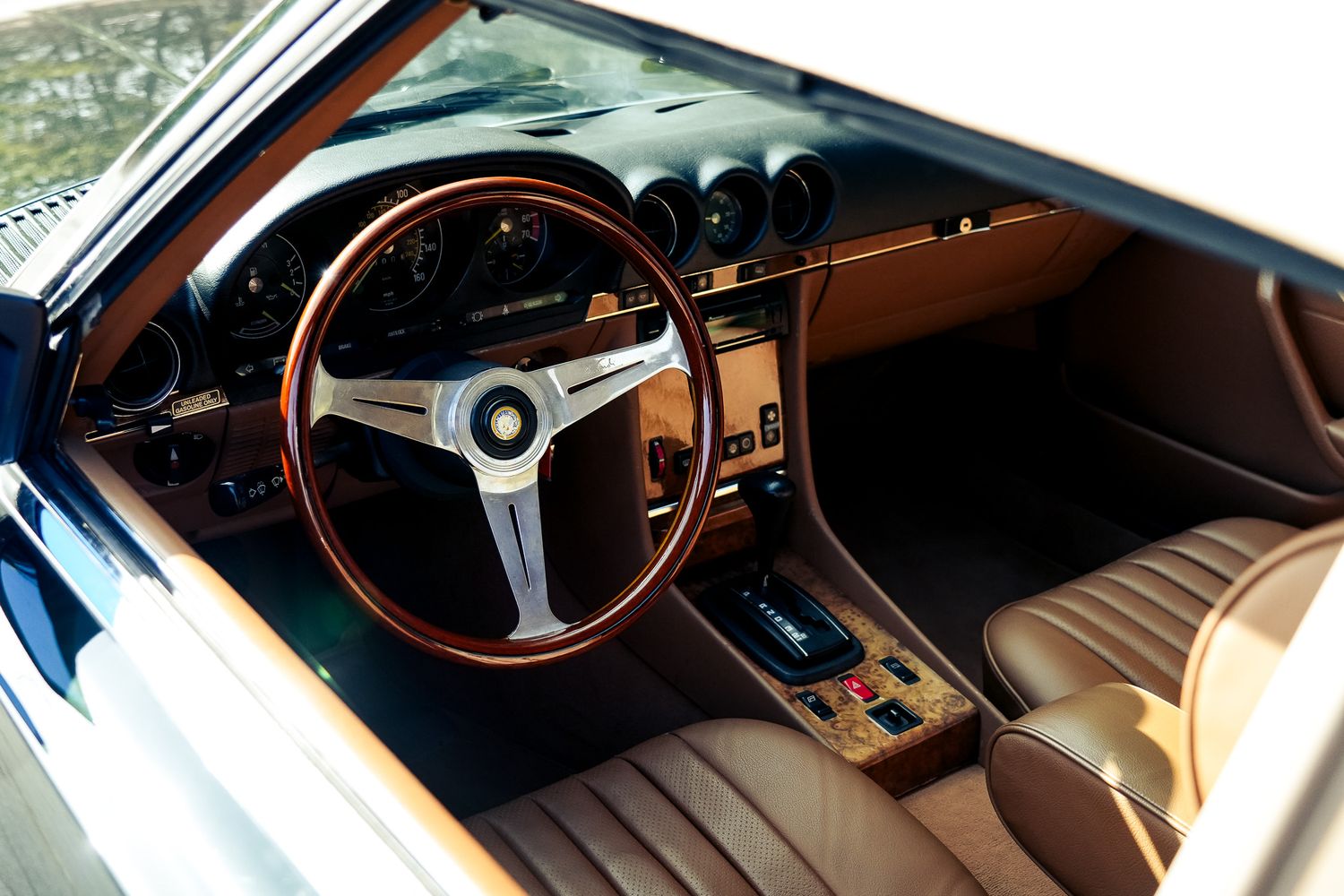 Elegant vintage car interior showing dashboard and steering wheel details.