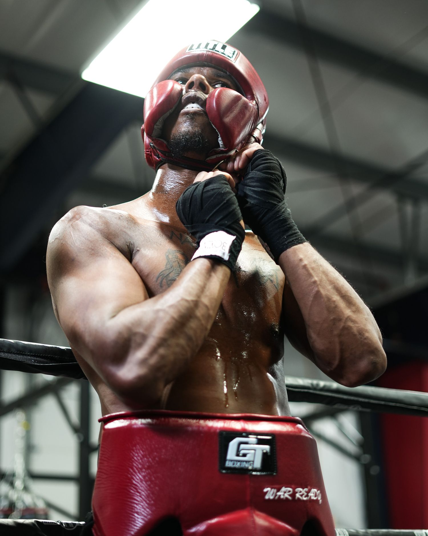 Close-up of boxer hitting a red punching bag during training.