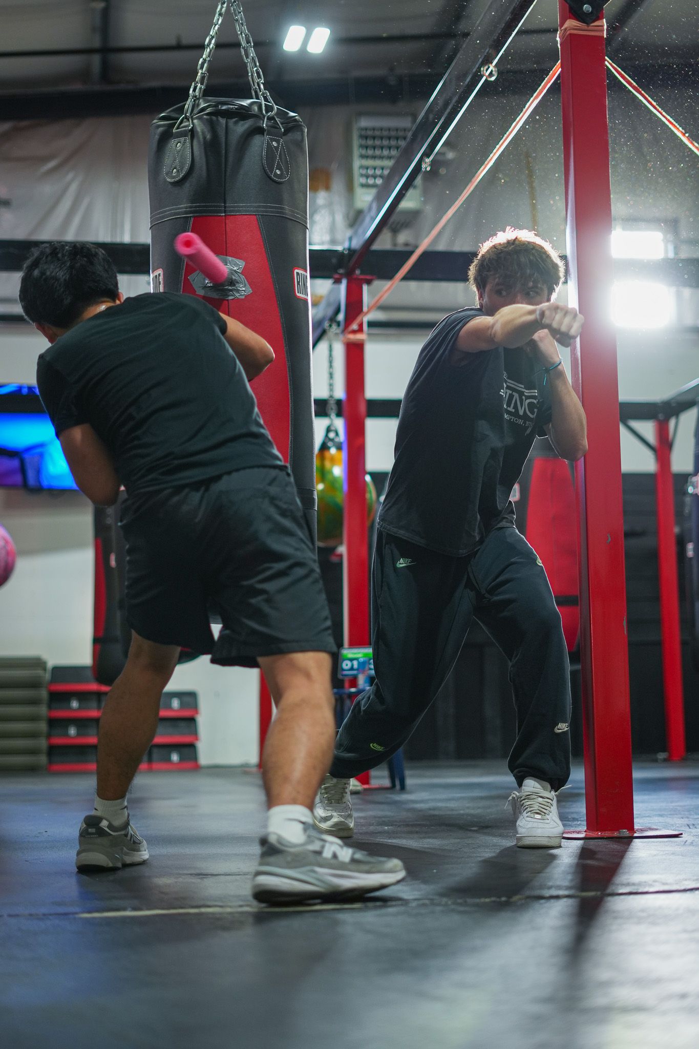 Low angle shot of boxers doing floor exercises in a gym.